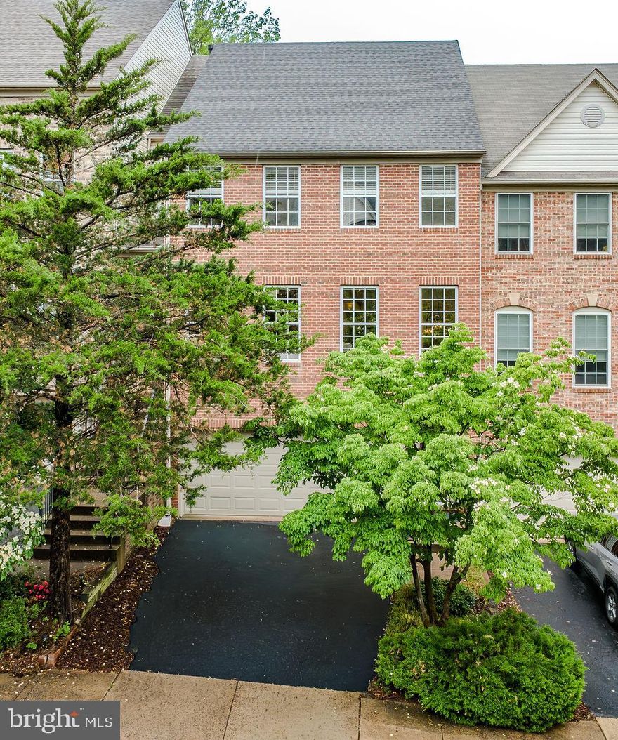 2-car garage brick townhome in the heart of Fair Lakes has 3 fully finished levels and a private driveway. Surrounded by mature trees and foliage, offering privacy and quiet amidst the shuffle of life. Enter on the ground level with elegant split foyer staircase leading to the main living level. With freshly refinished solid hardwoods and floor-to-ceiling windows, light from all angles illuminates every inch of the home, filling it with warmth.
Newly updated kitchen with herringbone, subway tile backsplash and artfully styled cabinetry with designer hardware. All new pendant and recessed lights create ambiance for entertaining that spills out onto the deck, or for cozy dining-in by the fire. A huge center island with counter seating abuts the kitchen table area or family room/den that offers versatile living spaces for all of your family’s needs . Large deck freshly painted, overlooks greenspace, mature foliage and a playground amidst the trees.
Separate formal dining room off of the kitchen steps down to the bright and open family/living room, spacious and light-filled.
Brand new carpeting on the upper level, elegant entryway steps up to the primary bedroom with vaulted ceiling & beautifully updated bathroom. Brand new double vanity with quartz countertop, new light fixtures & mirrors (2026). Primary shower newly tiled (2022) with separate soaking tub and recessed lighting. Secondary full bathroom upstairs updated 2026.
Lower-level recreation room with 3rd full bathroom (updated 2026), walks out to a brick paver patio and beautiful Japanese maple trees dancing along the fenced, rear yard. New Maytag washing machine (2023) and new Maytag dryer (2026).
Designer light fixtures and fans add custom touches throughout the home. Freshly painted top to bottom with updated door hardware, this home has an air of sophisticated elegance from the driveway to the back gate.  A fresh and neutral canvas on which to put your personal shine!  New Roof 2019 and New HVAC 2020 (whole system).
Beautifully located with quick access to a multitude of commuter routes, yet tucked amongst mature trees and the privacy of suburban Fair Lakes Court, you can have the best of both worlds. Enjoy Fair Ridge Park, FX County Pkwy Trail with miles of walking & bicycle trails (with access to Lake Zasada Community Park.  Minutes from Fairfax Corner, Fairfax Towne Centre, Fair Oaks Mall, Fair Lakes shopping with fine dining & eateries, shopping and entertainment.  Wegmans & Whole Foods both within minutes of your front door.  Unbeatable location for all that Fair Lakes has to offer with easy access to everything!