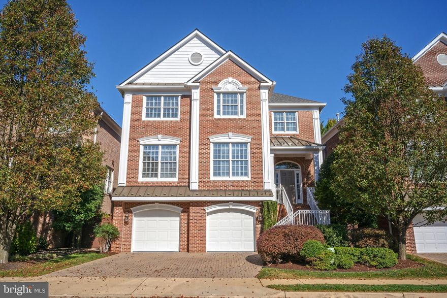 Arden Oaks presents a timeless community of stately, all-brick colonials crafted by Dittmar, ideally situated just moments from the vibrant heart of Tysons. Nestled on a peaceful cul-de-sac, this exquisite Belmont model has undergone an extraordinary transformation with over $475K in thoughtful updates.  From the brick driveway and elegant steps, guests are welcomed into an impressive extended-height foyer. The main level showcases refined touches, including heavy crown moldings, sand-in-place oak hardwood floors, and plantation shutters. A front office with striking coffered ceilings, accessed through double glass doors, offers flexibility as a main-level bedroom with its own closet. The formal dining room, framed by square columns and detailed with chair rail, creates an inviting ambiance for intimate gatherings.  Beyond the remodeled powder room, the butler’s pantry and kitchen have been completely reimagined as a culinary masterpiece. Cherry hardwood cabinetry, ice-brown granite countertops, and a stunning stone-and-glass mosaic backsplash set the stage. Professional-grade appliances, including a 48” Monogram refrigerator, Wolf cooktop, and cabinet-paneled range hood, elevate the space, while a center island with a raised breakfast bar and a built-in glass-paneled credenza in the breakfast room enhance functionality and style. Triple sliding glass doors, complemented by transom windows, flood the breakfast and great rooms with natural light and open seamlessly to the newer Trex deck. Anchoring the great room is a gas fireplace with a sleek marble-style quartz surround.  A switchback staircase with elegant iron balusters leads to the upper level, where newer solid oak hardwood floors lend a polished finish. The primary suite is a sanctuary, featuring a tray ceiling, two spacious walk-in closets, one with custom organizers, and a fully remodeled bath. Indulgent details include radiant-heated marble flooring, split oversized white vanities with granite countertops, a private water closet, and a luxurious walk-in shower adorned with floor-to-ceiling marble-style tile and a rain showerhead.  Convenience defines the upper-level laundry room, outfitted with overhead cabinetry, a utility sink, and extra storage. Two additional bedrooms share a remodeled hall bath, which features a double-bowl vanity, marble countertops, a walk-in shower with frameless glass doors, and a separate soaking tub.  The walk-out lower level is a haven for relaxation and entertainment, offering a bright recreation room with double sliding glass doors, a versatile bedroom or gym, a full bath, and a meticulously designed two-car garage. GarageTek floors & slatwall storage system, recessed lighting, and a storage closet make this garage truly exceptional.  Outdoors, the Trex deck and paver patio overlook a professionally landscaped, fully fenced rear yard. Stepping stones lead to side gates, enhancing both function and charm. Ideally located near major commuter routes, the Silver Line Metro at Tysons Corner and Dunn Loring, as well as premier shopping and dining at Merrifield's Mosaic District and Tysons Corner Center. NEWER Kitchen. NEWER Baths. NEWER Roof. NEWER Deck. REPLACED HVAC.