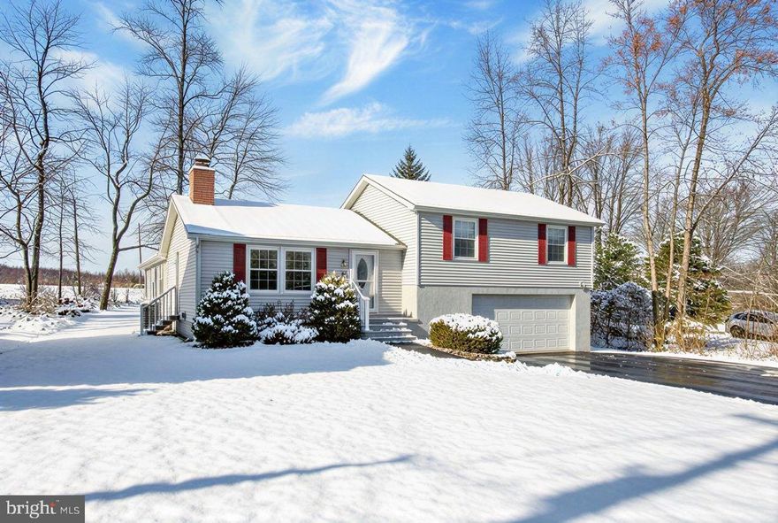 Welcome to your new home in Lake Meade!   This home offers a first-floor primary bedroom suite, a spacious family room with a propane fireplace, a kitchen/dining area, a living room & a bright, cheery sunroom overlooking the open pasture at the rear of the property. The second floor offers three bedrooms and two full baths.   The lower level is accessed through the attached oversized 2-car garage and provides a utility room and a bonus room that could be used as a work-out area, office, or hobby room.   Spacious lot with a blacktop driveway!   Your new home is waiting for you, and showings will begin the 3rd week of December.  Be sure to contact your agent to schedule your tour!   Lake Meade is a private, gated community with a 300-acre lake, ideal for sailing, wakeboarding, waterskiing, canoeing, kayaking, fishing, swimming, and pontoon cruising, with beautiful sunsets year after year.  With 10 HOA-maintained rec areas, you will find a wide variety of activities, including volleyball, basketball courts, tot lots, and picnic areas throughout beautiful Lake Meade.