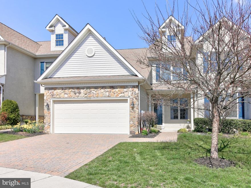 This spacious townhome has a perfect layout. Upon entry is a warm living room with wainscoting and hardwood floors that lead you throughout the home. Down the hallway past the elegant staircase is the kitchen and dining room space. The kitchen has a granite island with room for seating. There is plenty of cabinetry in the kitchen, a pantry closet, and matching black appliances. The French door and matching floor-to-ceiling window allow for some fantastic natural light into the dining room and kitchen. The French door opens onto the composite deck where you can entertain and grill. The first-floor laundry room with a utility sink has a door to the two-car garage. The powder room is tucked past the staircase along the hall. Quietly positioned at the back of the house is the master oasis. The bedroom has a sweeping vaulted ceiling and well-placed privacy windows and two fabulous closets. The attached master bath has double sinks with a vanity space between to sit. A full-size shower, and separate soaking tub to relax. Back up the front staircase is the loft/den/flex space. You can decide how you d like to utilize the area. It has a huge closet for storage. There is a spacious hall bath with a double vanity and full walk-in shower. There are two spacious bedrooms on this floor, and each bedroom has a huge walk-in closet. The basement is unfinished and has a hook up for a bathroom and a safety exit window if you want to finish the space or have a legal bedroom built out. There is a sump pump and the hot water heater is from 2018. An age restriction for the community limits occupancy to be 19 or over and one owner needs to be over 55 years of age. Because of the current ratio of the community, the new owner can be 45 years of age.