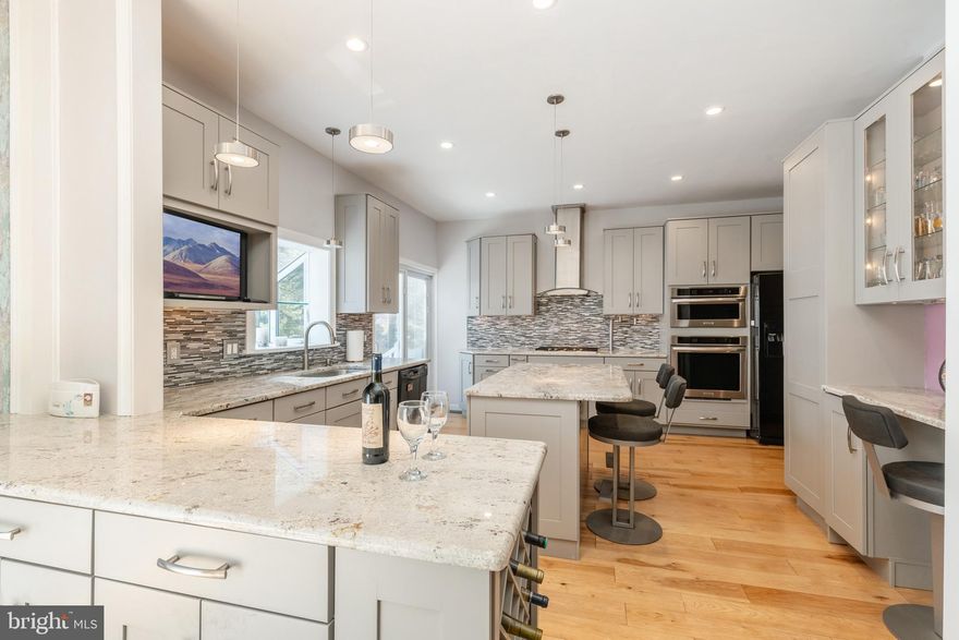 Presenting an unparalleled opportunity in Villanova, nestled within the esteemed confines of Lower Merion Township, this magnificent mid-century modern residence from the 1950s beckons your attention. Situated on an expansive (.80 acre) corner lot within a highly sought-after neighborhood, this property offers a picturesque setting that is sure to captivate.  Let's commence with its enviable location. Conveniently located at 401 Clairemont, this home enjoys close proximity to the newly constructed Black Rock middle school, Villanova University, and the Villanova train station. The neighborhood's serene streets, characterized by gentle undulations and minimal traffic, are ideal for runners, joggers, and dog walkers. Furthermore, the Lower Merion School District  bus stop is conveniently positioned directly across the street, while prestigious private schools such as Shipley, Baldwin, Agnes Irwin, Academy of Notre Dame, West Hill School, and Archbishop Carroll are all within easy reach. Now, let's delve into the home itself, which boasts an array of impressive features. Upon entry, you'll be greeted by the distinctive design elements of the 1950s, showcased in the spacious living room adorned with vaulted ceilings, expansive picture windows, and a cozy fireplace.  The recently renovated kitchen is a culinary haven, featuring cedar hardwood floors, elegant shaker cabinetry, granite countertops, a central island with seating, contemporary backsplash, built-in wine rack, modern lighting and fixtures, high-end appliances, pot filler, a warming drawer, and a well-appointed desk/work area. Adjacent to the kitchen, the dining area seamlessly transitions to a large patio, blurring the lines between indoor and outdoor living spaces. Furthermore, the home boasts a professional office suite with a separate entrance that has been approved by the Lower Merion Zoning commission to function as a low traffic, "minor home occupation".  (This approval will be transferred to the new owner).  This space could also be used as a fifth bedroom or in-law suite. The lower level presents a comfortable family room with access to a lower patio, a dedicated laundry room, a full bathroom, and a versatile multipurpose room, originally part of the garage but converted to living space for added square footage. Upstairs, you'll discover four generously sized bedrooms, including a primary bedroom with three closets and an ensuite bathroom featuring dual vanity and a spacious shower with multiple shower heads. An additional bathroom serves the remaining bedrooms, while the common hallway offers two linen and storage closets, further enhancing the home's functionality. A highlight of the property is the fully enclosed, heated indoor pool, which is accessible from an indoor passageway or outside deck. The pool area, approximately 28½ x 56½  in size, serves as an oasis for leisurely swims and entertaining guests. Additionally, a sizable deck adjacent to the pool provides ample space for outdoor gatherings. Notable updates to the property include brand-new patios and front walkway, as well as recently redesigned landscaping. With an unfinished basement offering ample storage space, this home offers an unparalleled living experience. Schedule your appointment today to experience the allure of this exceptional property firsthand!