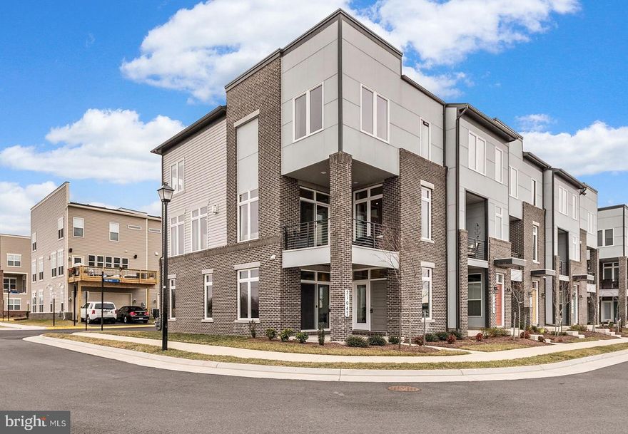 Don't miss this sophisticated and modern 3-bed 2/2-bath END unit townhouse! Enjoy hardwood floors throughout main living area, and custom windows that flood this home with sunlight. Flowing, open floorplan accented with luxurious 2-way gas fireplace and upscale lighting! Entertain a crowd in this stunning kitchen with expansive counters, ample cabinetry, sparkling granite, and all stainless-steel appliances. Gorgeous master bedroom boasts spa-like en suite master bath with his-and-hers vanity. Relax on 2nd level balcony offering fantastic views of the surrounding landscape. 2-car garage. Less than 1 mile to grocery stores, retail, and restaurants. Easy access to walking paths, parks, golf course, and Dulles Toll Road!