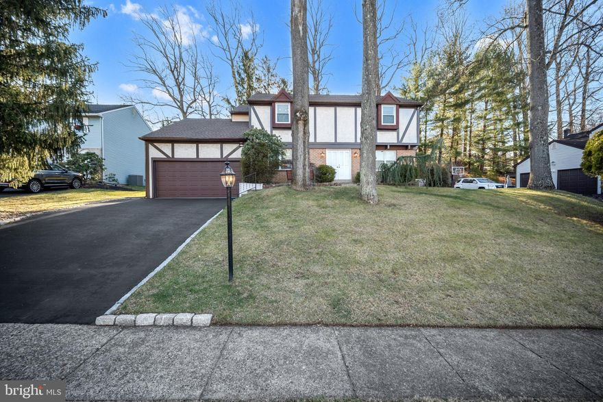 Welcome to 853 Green Ridge Circle, a beautifully upgraded 4-bedroom, 2.5-bath Colonial located in the highly sought-after Woodlyn Crossings community, offering the privacy of a single-family home along with exceptional neighborhood amenities including a pool, tennis courts, and playgrounds, all set among peaceful wooded walking paths. This light-filled home features gleaming hardwood floors and recessed lighting throughout, creating a bright and inviting atmosphere from the moment you enter. The open layout is enhanced by crown molding on the main level, a granite eat-in kitchen with matching granite table, and updated bathrooms with modern finishes. The primary bedroom offers generous storage and a private bath, followed by a spacious hall bathroom, and nice-sized secondary bedrooms, with the bedroom adjacent to the primary suite being exceptionally large and highlighted by a vaulted ceiling. The finished basement includes a very well maintained crawl space ideal for extra storage. Recent upgrades include a brand-new roof installed in March 2025, upgraded windows, a new rear exit door, and an automatic whole-house generator. An upgraded laundry room opens directly to the private backyard featuring a tiled patio and motorized retractable awning, while a well-kept two-car garage and freshly coated driveway complete this move-in-ready home — make your appointment today.