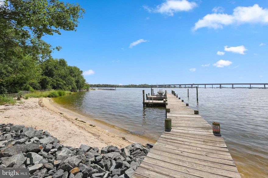This 3 bedroom 2 full bathroom newly renovated cape cod sits on over an acre of land. This lot has a sandy beach that runs the entire 105 feet of water frontage in addition to a dock with a boat slip and 5 feet of mean low water. The dock also has a grandfathered in picnic table area where one could enjoy crab picking under and umbrella. This home is located right next to Peach Orchard Park creating a vast and unobstructed view of wildlife and a peaceful rural ambiance. This home sits at the mouth of Bear Creek making a boat trip to the Inner Harbor a short 10 minute ride and a driving distance to Canton only 12 minutes. This home has so many custom features from the refurbished wooden trim throughout, to the custom mid way high bathroom vanity, to he arched top door leading to the owners suite closet. The yard has so much potential because of the size and level grading. One could add an in-ground pool with patio, a garden, or anything you could imagine. Come enjoy a tour of this beautiful one of a kind property. It won't last long.