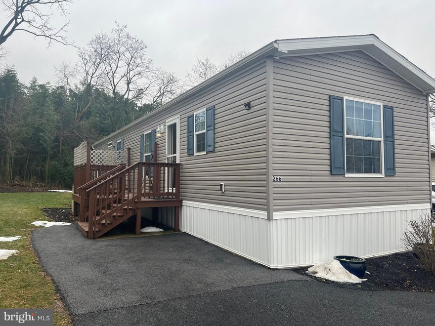 Welcome home to 266 Beechwood!  This meticulously maintained 2 bedroom / 1.5 bath home was built new from the factory by the current owner in 2018 with many added upgrades.  Drywall in place of paneling,  extended width model, and half bath added to second bedroom are just a few of the many upgrades the current owner chose to do!  Upon entering the home, you will be greeted by an open and inviting living area with recessed lighting, providing a modern yet comfortable feel.  The living area flows freely to the dining and kitchen area.   The primary bedroom has a walk in closet, full bath and a large window with a view of the woods behind the home.  Exterior amenities include a porch over-looking the back yard and woods behind home, a shed, and an oversized driveway allowing for parking of two vehicles.  This home is walking distance to Northern Schools and Downtown Dillsburg while still providing easy access to Route 15.  Pride of ownership shows all throughout this home.  Schedule your showing today!