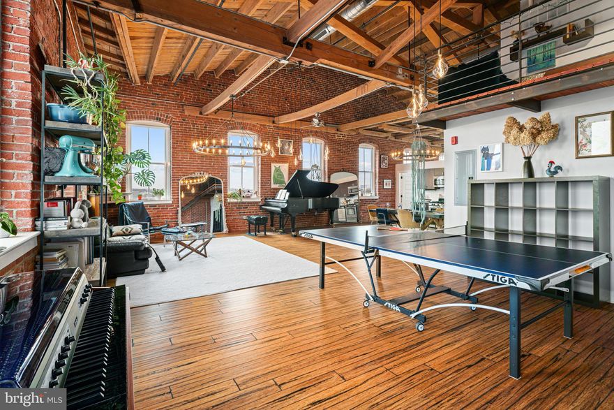 Welcome to 2551 Trenton Avenue, Unit 401, an exquisite top-floor corner penthouse nestled in the vibrant neighborhood of Fishtown, Philadelphia. This elegant 2-bedroom, 1 bathroom industrial loft spans an impressive 1,700 square feet, offering a unique blend of modern luxury and industrial charm.

As you step into this top-floor corner unit, you're greeted by an abundance of natural light streaming through expansive windows, highlighting the stunning exposed brick and original wood beams. The open-concept layout is accentuated by high ceilings, hardwood floors, and custom design fixtures throughout creating a sophisticated yet inviting atmosphere.

The spacious living area boasts a Juliet balcony with breathtaking city views, perfect for enjoying your morning coffee. The elevated loft space provides versatility, ideal for a second bedroom, home office, or media nook. The kitchen is a chef's dream, featuring stainless steel appliances and ample counter space.

Residents enjoy a range of upscale amenities, including secured mail room and a voice intercom system for added convenience. The building features an elevator and is pet-friendly, ensuring all your needs are met. Parking is a breeze with your assigned space in the secured gated parking lot.

Located in one of Philly's most bustling neighborhood, this home offers proximity to world-renowned culinary experiences and the vibrant energy of Fishtown. Some notables within walking distance are Post Haste, Picnic, Mural City Winery, Starbolt, and Philadelphia Brewing Company.

Experience the perfect blend of style and comfort in this exceptional residence