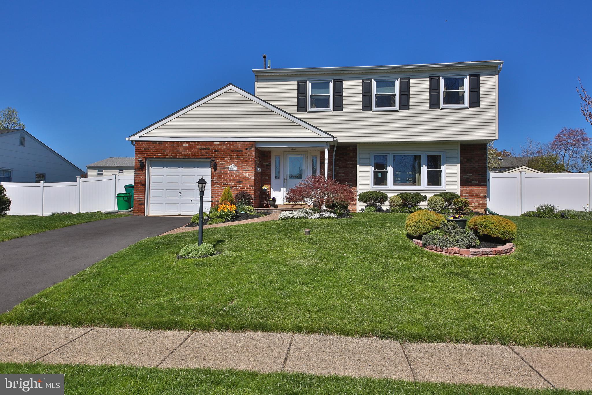 Discover your perfect retreat in the sought-after Drexelwood neighborhood! This meticulously maintained 4-bedroom, 2.5-bathroom single-family home blends classic charm with modern upgrades. A welcoming paver entrance, framed by beautifully landscaped gardens, sets the tone for this inviting residence. Step inside to a light-filled first floor featuring a spacious living room with oversized windows, an elegant dining room (both with finished hardwoods underneath carpet), and a large eat-in kitchen. The cozy family room off the kitchen, complete with a charming wood burning fireplace with gas logs, flows seamlessly to a private backyard oasis—featuring a new covered patio, vinyl privacy fencing, and vibrant perennials.
Upstairs, find four generously sized bedrooms, including a luxurious master suite with ample closet space and an en-suite bathroom. The remodeled hall bathroom serves the remaining bedrooms, all showcasing newly finished hardwood floors (with hardwood extending beneath carpets in master suite). The one-car garage offers extra storage, and a house generator electric hook-up to provide peace of mind. Recent upgrades include a newer roof, windows, and siding for enhanced efficiency and curb appeal.