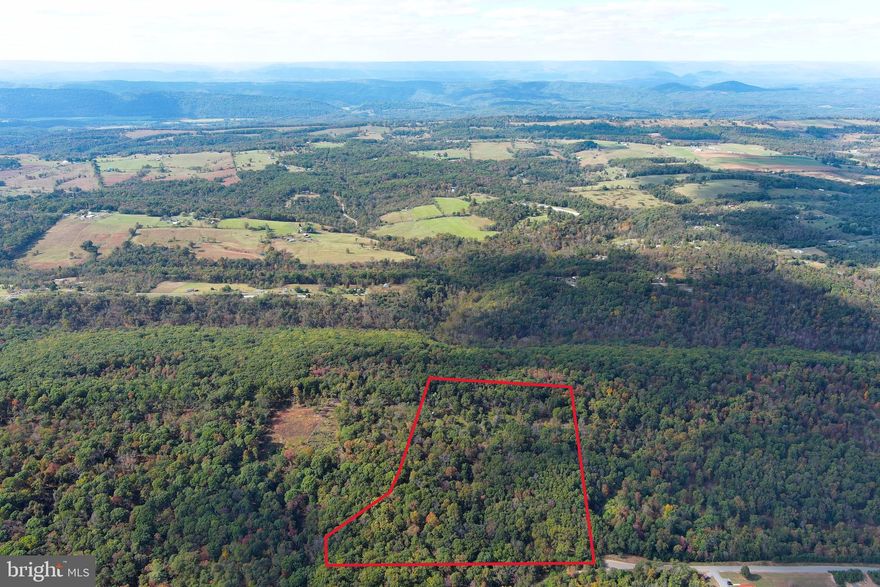BIG LONELY RIDGE.....20 WOODED ACRES PERCHED A TOP TOWN HILL, ELEVATED AT 1400 FT ABOVE SEA LEVEL, THIS PROPERTY OFFERS YOUR CHOICE OF FANTASTIC VIEWS....TAKE YOUR PICK....SOUTHEAST OR NORTHWEST....YOU OWN BOTH SIDES OF THE BIG WIDE RIDGE.....THE CHOICE IS YOURS AND YOU CAN'T GO WRONG! GENTLY SLOPING OPEN HARDWOOD FOREST WITH TOWERING WHITE OAKS. EXTRA WIDE OLD LOGGING ROAD PROVIDES DRIVEWAY TO RIDGE TOP AND THERE ARE OTHER TRAILS ON THE PROPERTY FOR ATV'S. LOCATED IN QUIVEY'S GROVE, A SMALLER GATED COMMUNITY OF 20+ ACRE TRACTS IN THE CENTRAL AREA OF HAMPSHIRE COUNTY, MORE CONVENIENTLY LOCATED THAN MOST OF THE LARGER 20+ ACRE LOT COMMUNITIES.....CLOSER TO NORTHERN VIRGINIA AND ONLY 15 MINUTES FROM SHOPPING, RESTAURANTS AND HOSPITAL.....YOU'RE OUT THERE....BUT NOT THAT FAR OUT THERE. THIS IS A GREAT LOT, SUITABLE FOR ANY APPLICATION; BUILD, CAMP, HUNT, SHOOT, ATV'S....POWER & PERKED.....THIS ONE'S NOT A ROLL OF THE DICE, IT'S A WINNER EVERY TIME!