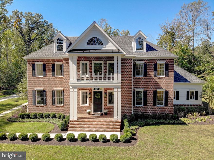 Stately custom home set on a private, tree-lined lot in Davidsonville’s exclusive gated community! Only 3 years young, this residence offers over 6,000 finished square feet of thoughtfully designed living space. A grand two-story foyer with curved staircase and overlook introduces the home’s elegant flow, while the spacious open floor plan creates a sense of grandeur ideal for gatherings both large and small. Impeccably maintained, the home features quartz countertops, curated lighting, panel-covered appliances, premium fixtures and hardware, solid wood doors, and detailed millwork, with thoughtful design elements that create continuity and elevated style in every space. At the heart of the home, the dramatic great room boasts a coffered ceiling, custom built-ins, and a gas fireplace, with expansive doors leading to a brick patio for seamless indoor-outdoor living. The gourmet kitchen features an ILVE gas range, oversized island, dual-drawer dishwasher, multiple pantries, and custom cabinetry. The main-level primary suite offers its own brick patio, electric fireplace, dressing area with custom closet built-ins, and a spa-inspired bath retreat with dual private water closets. Upstairs, three bedrooms are true en-suites, each with a private bath and built-in closet organizers. The finished lower level presents a bedroom with full bath, a media room designed for gaming or big-screen viewing, and a generous recreation space suited for a teen lounge or flexible living. A dedicated storage room also provides interior access to the garage. The home also includes abundant storage with a spacious laundry room and thoughtfully placed closets, helping a busy household stay effortlessly organized. Car enthusiasts will love the attached 3-car garage plus a secure 4th bay designed to lock and fit a car lift. A detached studio with loft, half bath, and a private recording room with state-of-the-art lighting system creates a versatile retreat, perfect as a creative studio, yoga oasis, design space, or podcast room. Too many upgrades to list, see the video tour, browse the photos, and schedule your private showing today! Some photos are virtually staged.