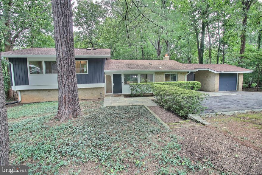 The Saenger Group welcomes you to 8322 Still Spring Ct, Bethesda, MD 20817

Nestled in the highly sought-after Carderock Springs community, this beautifully renovated and freshly painted mid-century contemporary home offers a harmonious blend of classic charm and contemporary upgrades. Perfectly positioned on a 0.40-acre lot on a quiet cul-de-sac, it's just a short hike from the community pool and tennis courts.

This four-bedroom plus den, three-full-bath home boasts exceptional design with walls of windows, vaulted ceilings, skylights, updated lighting, and gorgeous wood flooring. The inviting foyer opens to an open floor plan featuring a stunning living room with a wood-burning fireplace, floor-to-ceiling windows, and access to a private multi-tiered deck and patio. The heart of the home is the open-concept dining room, family room, and kitchen, ideal for entertaining. The kitchen features elegant quartz counters, updated appliances, handsome cabinetry, and a large sliding door to a breezeway drop zone with garage and driveway access. The dining room connects seamlessly to the family room, which offers gabled ceilings and glass doors to the expansive deck, blending indoor and outdoor living.

The upper level includes three bedrooms and two updated full baths, highlighted by a spacious primary suite with a private bath and ample closet space. The walk-out lower level provides a spacious recreation room with backyard access, an additional bedroom and office, a modern full bath, and laundry/storage space.

The exterior is equally impressive with a detached garage, a welcoming covered side entry, an expansive deck, a stone patio, and lush landscaping.

Carderock Springs is a vibrant community known for its mature landscaping, community pool, pool house, tennis, and pickleball courts. Ideally located just outside the 495 Beltway, it provides easy access to DC, Northern Virginia, I-270 Corridor, and downtown Bethesda's renowned dining, shopping, and entertainment. It is part of the Walt Whitman High School cluster (Carderock Springs Elementary, Thomas W. Pyle Middle School, and Whitman High School). Enjoy proximity to Potomac Village, Cabin John (grocery, restaurants, salon, gym), the MacArthur bike path, Cabin John Park, Glen Echo Park, and Great Falls.

Don’t miss this rare opportunity to own a one-of-a-kind property in Carderock Springs, combining an idyllic park-like setting, breathtaking wooded views, and exceptional livability.

*** Offers due by 3:00PM on Tuesday 7/22/2025.