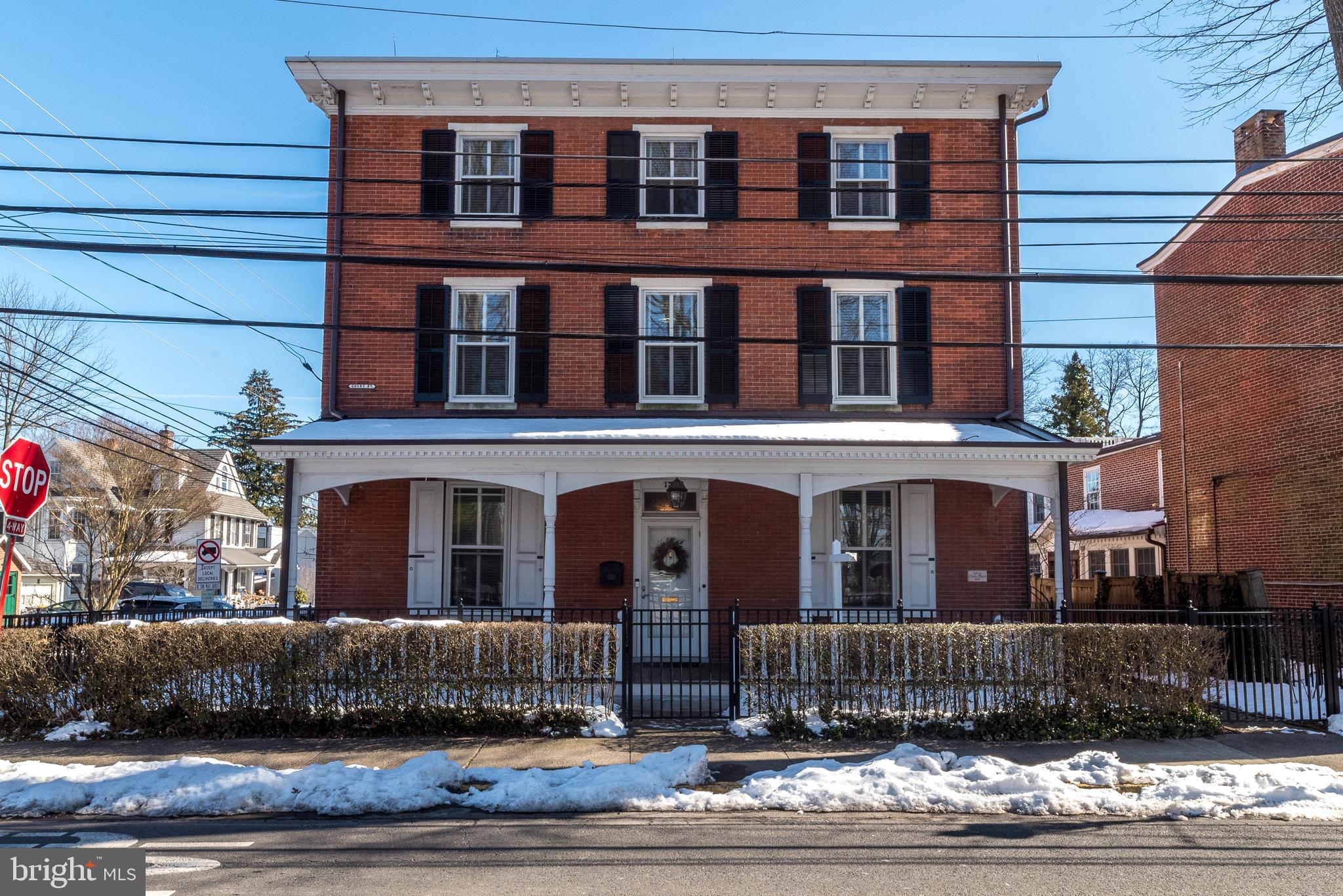 This stately home is situated perfectly on a spacious corner lot in the center of Doylestown Borough. The brick exterior lends itself to a timeless era while the interior updates offer modern sophistication. Dating back to 1867 it is a mix of historic features with an updated flare. The impressive front porch offers a shady spot to relax. This beautiful home offers 3908 feet of living space on three floors. The first floor boasts ten-foot ceilings throughout with mostly hardwood. The gorgeous molding and deep window wells add to the ambiance. The floor plan lends itself to versatility depending on your needs. A beautiful gas-burning fireplace can be found in the spacious family room with folding French doors allowing the light to enter brightly. You will love the custom built-in shelving for storage and display. In the rear of the first floor, you will find a newer addition that offers a kitchen for a chef with a cathedral ceiling, gorgeous cabinetry, a six-burner Wolfe commercial range including double ovens, and a Sub-Zero refrigerator. In addition, there is a large island with a built-in microwave, warming drawer, and under-counter beverage cooler. Exposed brick, granite countertops, and recessed lighting complete this modern space. The sunny breakfast area encompassed with windows and a full view atrium door leads to the rear yard brick patio where you will find the perfect spot for outdoor living and entertainment. A brick walkway leads to the oversized two-car garage with an upper storage area. The second floor offers impressive nine-foot ceilings, a spacious master bedroom with a large custom walk-in closet, a master bath, and a private water closet. A second bedroom, sitting area, and full bath can be found on this floor. The third floor offers a bedroom with an office/sitting room, a nice-sized library, and two additional bedrooms that lead to a shared hall bath. Need more space? The unfinished basement is readily available for a gym, game room, wine cellar, or whatever you desire. An elevator is the perfect surprise, making it easy to access all three floors with the touch of a button. This beautifully finished historic home offers all the conveniences you need with accessibility to some of the best dining, shops, and cultural attractions just a short walk away. Don’t wait to start living your best life.