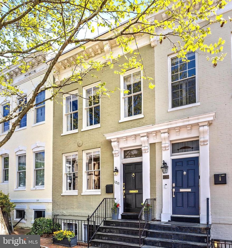 Welcome to this stunning Georgetown home in the heart of the East Village! This approx 2,500 sq. ft. home features wonderfully high ceilings throughout, beautiful hardwood floors, tons of natural light flooding through newly replaced windows, and even has a fireplace on each level. The main level has a large living room with an elegant mantle and fireplace and graciously flows into the dining room defined by decorative molding. There is an additional separate den or home office before leading to the kitchen / family room in the back. The kitchen renovation features high-end, stainless-steel appliances including a Sub-Zero fridge, gorgeous Ultracraft cabinets, glass tile backsplash and Caesarstone white countertops. The family room has French doors leading to the rear deck and idyllic rear garden. The upper level features a generous primary suite with fireplace, ensuite bathroom, large walk-in closet and additional closet providing ample storage. Down the hall is the second full bath just before the second bedroom which has a charming bonus room attached - it would make for a bright and sunny home office. The newly renovated bathrooms all feature beautiful Porcelanosa fixtures. The lower level is a separate English basement which has been completely updated featuring a large living room with a cozy fireplace, a full kitchen, dining area, and a generous bedroom with full bath. This separate lower level unit would make the perfect in-law suite or income producing space!