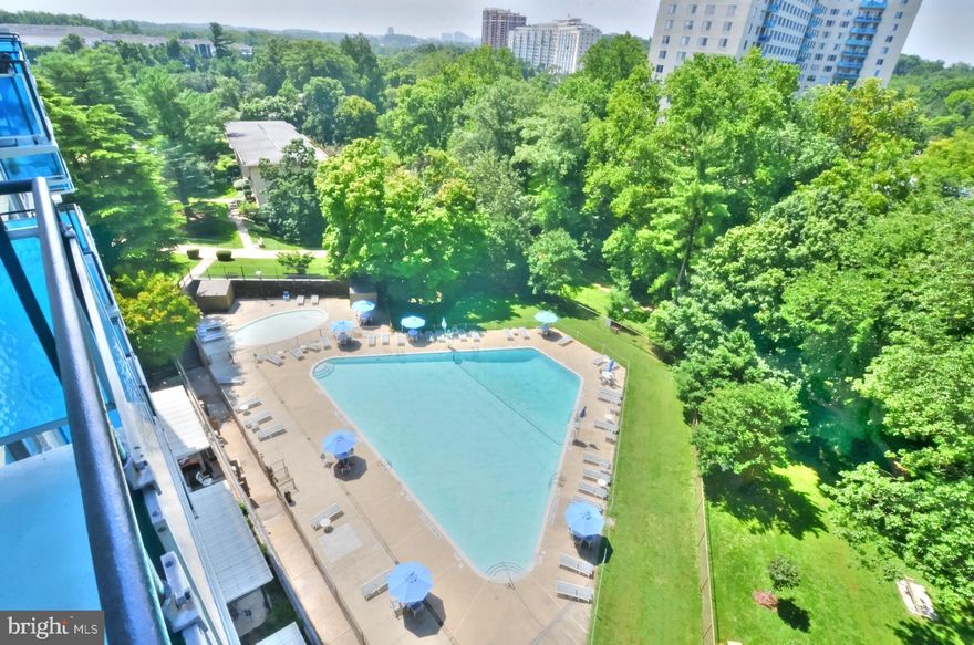 This home is filled with abundant natural light, creating a vibrant atmosphere that is sure to please!  Situated on the 7th floor,  each room offers stunning panoramic views of the surrounding trees that will leave you in awe!   With two bedrooms and two bathrooms, this home showcases wall-to-wall windows and elegant hardwood flooring throughout.  As you enter, the open living room and dining room provide great space for both entertaining guests and unwinding in comfort.  Off the dining room, you can enjoy moments of relaxation on the spacious balcony surrounded by views of the lush grounds and inviting pool that form a picturesque backdrop.   The kitchen provides ample cabinets and counter space allowing for easy meal preps.  An additional entrance to the kitchen adds convenience, making it effortless to unload groceries!  Large owner's suite features hardwood flooring and an oversize window with delightful views of the surrounding trees.  The en-suite bath has been tastefully updated with tile flooring, decorative tiled shower as well as shelving and a medicine cabinet.  The generously sized second bedroom features plenty of closet space, hardwood flooring and magnificent treed views.  The second full bath includes  a tub/shower as well as shelving and a medicine cabinet.  Two separate storage closets offer great amount of storage space for all your seasonal/holiday items and all other necessities.  This unit also comes with Garage Parking Space #P-304 which is deeded separately.  ALL UTILITIES AND CABLE INCLUDED IN CONDO DUES.   Enjoy many of the community amenities including secured entrance, 24-Hour front desk concierge, rooftop party room, fitness center and outdoor swimming pool, EV Charging Station, library, game room, renovated laundry room with over twenty washers and dryers, bike rooms, shaded tennis courts and a walking/jogging path. Popular Grosvenor Market, a full service grocery store as well as Grosvenor Dry Cleaners are located right next door. Grosvenor Strathmore Metro is located directly across the street through the pedestrian tunnel. Minutes away from the Strathmore Arts Center, Pike and Rose shops and restaurants, major routes leading to Rockville, Bethesda and the downtown DC area.