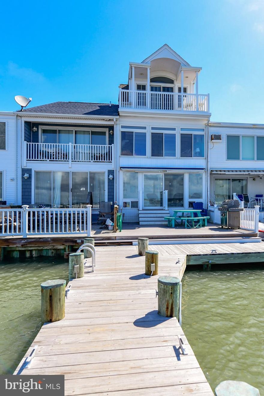 Striking DIRECT BAY FRONT home with million dollar views! This 4 level townhome with 4BR/4BA is  in pristine condition and has upgrades throughout. You will love the Bay front deck and sunroom for entertaining and relaxing.  As you walk into this beautiful home you will be immediately drawn to the expansive Bay views. The dining room also has magnificent Bay views and the kitchen has been upgraded with granite countertops. There is a large living area for family and friends to enjoy, and off the family room there are glass sliders leading to a Bay front sunroom.  There is a expansive deck for enjoying nightly sunsets and the large boat slip is certain to please the boating enthusiast in your family.  On the second level you will find a large master suite overlooking the Bay.  There is another bedroom and bath on this floor as well.  On the next level you will find another large Bay front bedroom and another bath and a Bay front deck. There is yet another bedroom on the third level   On the fourth level there is an extra loft bonus area and there is a fire sprinkler system throughout the house. This is a very large townhome that will accommodate a large family and there are NO HOA FEES.