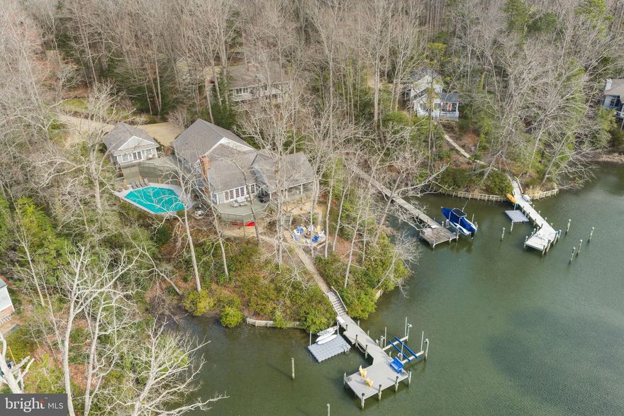 Turn-key waterfront living on Carter’s Creek in the heart of Irvington’s sought-after Glebe Road neighborhood. This 5-bedroom, 4-bath property offers the ideal blend of comfort, entertaining space, and coastal charm, just a short walk or bike ride to Irvington’s shops, restaurants, and amenities. The main level features a stunning great room with vaulted ceilings, exposed beams, and expansive water views, flowing seamlessly onto a large wraparound screened porch and adjoining waterside deck, perfect for indoor-outdoor living. Three bedrooms are located on this level, offering convenient one-floor living. The lower level is designed for fun and flexibility, featuring a spacious rec room with bunk area, full bath, and walk-out access to the pool and waterfront ideal for hosting family and guests. Outside, enjoy a beautifully landscaped waterside setting with a recently replastered gunite pool, fire pit, and multiple seating areas leading to a private pier with boat lift and floating dock on Carter’s Creek. A detached guest house provides additional privacy with a bedroom, full bath, and living area, with a garage located below. Offered fully furnished, this property is completely turn-key ready to enjoy from day one.