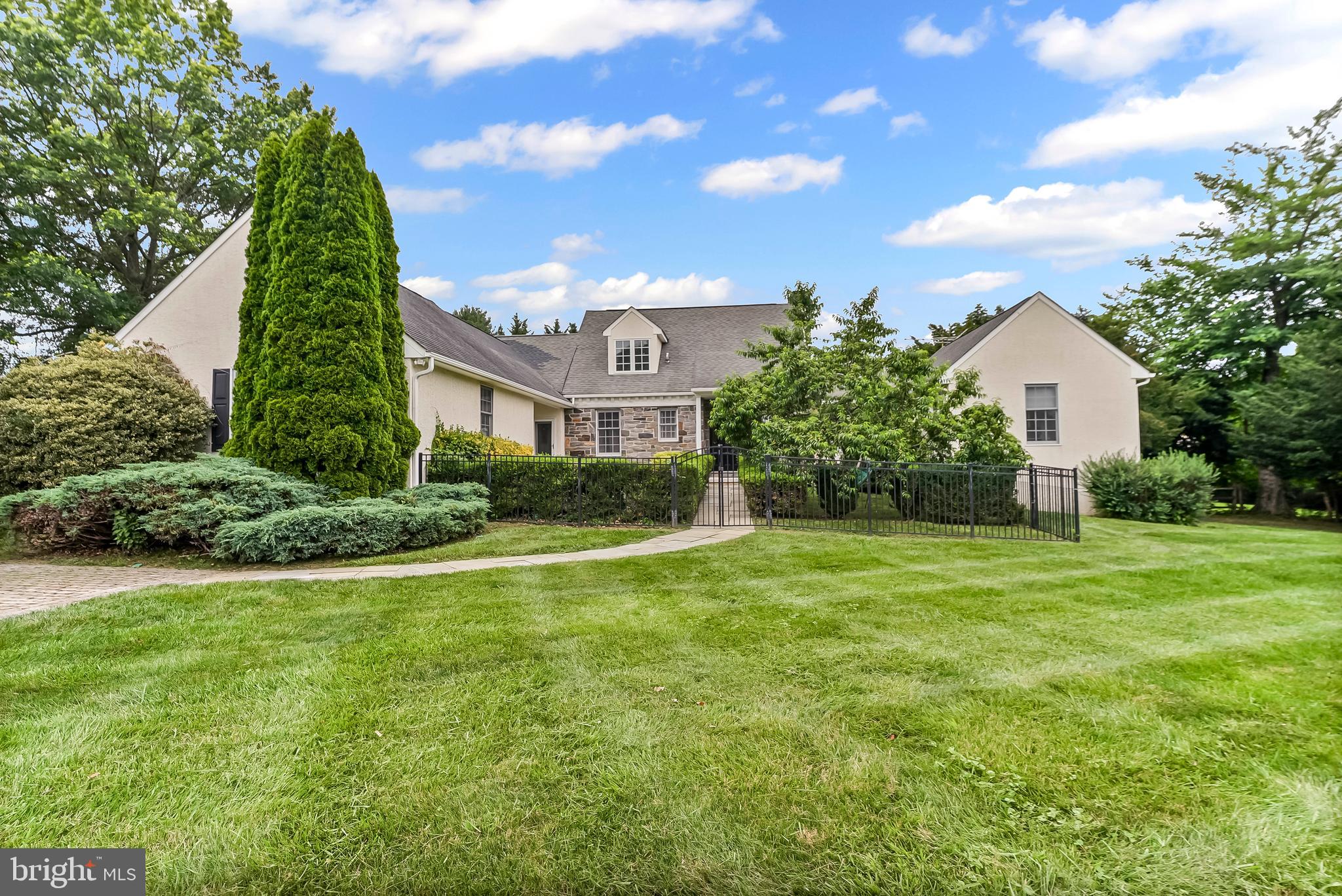 Discover this beautifully maintained custom-built stone-front home, perfectly sited on a private 1.2-acre lot in the desirable Garnet Valley School District. A lush, fruit-bearing peach tree greets you as you enter and the fully fenced rear yard offers privacy and tranquility. The private drive includes a paver parking area in addition to a spacious 2.5-car garage.
Inside, rich maple floors flow throughout the first floor, highlighted by 40 sun-filled windows, 3 French doors, and 3 French sliders, creating a bright, open atmosphere. plus freshly painted interior. The grand tiled foyer with a soaring cathedral ceiling sets the tone for the home’s elegant style.
The expansive great room features recessed lighting, a striking stone wood-burning fireplace, a built-in bar with wine refrigerator and sink, and two custom cherry built-in cabinets. French doors open to a large deck — ideal for entertaining. The formal dining room is enhanced with crown molding.
The chef’s kitchen boasts a vaulted ceiling, stainless steel appliances, a gas stove, a massive island, with rare blue Bahia granite countertops, a tiled backsplash, abundant cabinetry, a built-in desk, and a stained-glass door leading to the front patio. A sunny breakfast area with bay French sliders and ceiling fan opens to the deck, perfect for casual dining.
A spacious mudroom addition offers tile flooring, a sink, built-in storage cabinets, hanging space, ceiling fan, and an exterior exit. Additional main-level highlights include a tiled powder room and a versatile study with a built-in window seat.
The first-floor master suite is a true retreat, complete with a ceiling fan, walk-in closet, French doors, built-in vanity, and cabinetry. The spa-like master bath features a tiled floor, double sinks, a soaking tub, and a walk-in glass shower.
Upstairs, you’ll find three additional bedrooms — one with a ceiling fan — and a full hall bath with double sinks and a tub/shower combination.
The home also includes a 336-square-foot finished basement space with an exterior exit, plus abundant additional unfinished storage. All permits have been obtained, footers already poured and plans available for a sunroom addition.
This is a rare opportunity to own a truly special home with thoughtful details, both inside and out — perfect for modern living and entertaining. Located just 3 miles from the Wawa train station, close to major roads, health care and shopping.