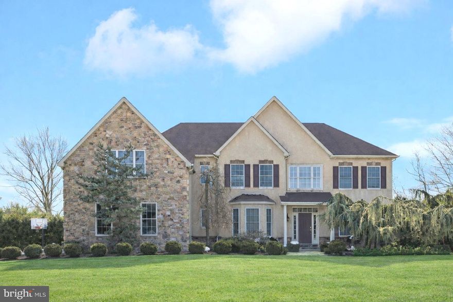 Set well back from the street on 2 private acres, this custom-built 4-bed, 3 full + 2 half bath + 6 car garage Colonial offers a rare mix of refined detail, generous space, and flexible living areas designed for today’s lifestyles. Step inside to hardwood floors, fresh carpeting, abundant natural light, and an inviting layout that balances formal rooms with comfortable gathering spaces.

A columned living room and elegant formal dining room create a polished first impression, while a dedicated office—lined with multiple windows—provides a bright, quiet place to work or create. The heart of the home is the kitchen, featuring a center island, pantry, eat-in area, black granite countertops, and ample prep space for everyday meals or entertaining. Gas cooking and a well-planned work zone make it easy to host, and the kitchen flows seamlessly into the great room with vaulted ceilings and a fireplace with a classic mantle.

From the kitchen, a slider opens to a covered flagstone entertaining terrace complete with an outdoor fireplace—ideal for three-season dining and relaxed evenings outdoors. Practicality meets convenience with an attached 3-car garage, an extra-wide driveway, and thoughtful first-floor amenities.

Upstairs, two staircases lead to four bedrooms, connected by a distinctive bridge overlooking the family room below. The primary suite is a true retreat with two walk-in closets and flexible bonus space that can serve as a sitting area, office, or gym. A dedicated laundry room adds everyday ease.

The newly finished basement expands the options even further, offering space for a gym, game area, media or lounge zones, plus extensive storage. Outside, the large grassy backyard provides plenty of room to garden, play, or explore the potential for a future pool. Completing the property is a separate 3-car garage with additional storage and a private 1-bedroom + 1- bath guest suite above—ideal for extended stays, creative studio space, or a quiet retreat.