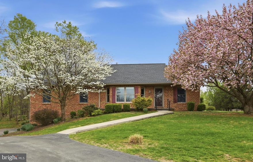 A rare gem nestled on over two pristine acres in a coveted water-access community, this stunning brick rancher offers the perfect blend of elegance, comfort, and natural beauty. Boasting four generously sized bedrooms and two full baths on the main level, the home is thoughtfully designed for both everyday living and effortless entertaining.  Step into the impressive living room, where a vaulted ceiling and a warm gas fireplace create an inviting, light-filled space, beautifully shared with the owner’s suite for a touch of everyday luxury.  Unwind in the tranquil glass-enclosed sunroom, where panoramic, park-like views showcase mature landscaping and abundant wildlife, offering a peaceful retreat in every season. With direct access from both the owner’s suite and the dining room, this space seamlessly connects indoor comfort with outdoor charm.
The partially finished basement expands the home’s versatility, featuring a full kitchen and full bath—ideal for guests, extended living, or entertaining.
Enhanced by recent updates throughout, this exceptional property is truly move-in ready and poised to deliver the lifestyle you’ve been waiting for.