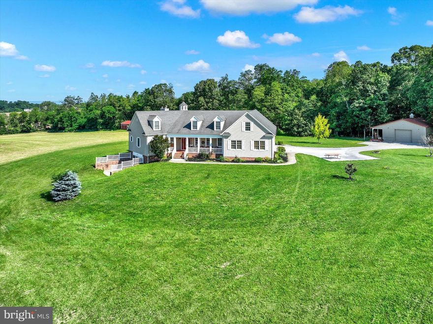 The "Haines Ranch" over 40 acres nestled within natures embrace, as you approach the property you're immediately struck by the grandeur of its Architectural design, with captivating front porch overlooking  the 1/2 acre stocked pond. The exterior exudes elegance with it's octagon roof line with octagon copula.  Step inside to an open floor plan and soaring octagonal Cathedral ceiling creating a sense of spacious grandeur. 9' ceilings on the main floor.  
      The kitchen is a chef's dream featuring generously sized island with a cooktop and custom made cabinetry, built in wall oven & microwave, breakfast nook leads to a screened in porch, octagon family room features stone fireplace with raised hearth. Sliders leading to the deck w/ spectacular vista views of the Catoctin Mountains and Ski Liberty to the west. 
     The Primary main bedroom suite is a retreat itself complete with a spa-like en suite bathroom and large walk-in closet. Additional main floor bedrooms on the opposite end of the home offer privacy for primary suite. There are 2 full and 2 half baths and laundry on the main floor. There is a huge finished lower level with walkout to a large patio, this level boast a spectacular open floor plan with full bath, family room and office area. There's  additional unfinished huge storage space that can be additional living space.  
     There is a beautiful oak staircase from main level leading to an amazing unfinished 2nd floor offering the possibility of additional living space or leave it just as it is currently, used as tons of storage space.
     The spring fed pond is stocked with large mouth bass, huge catfish and blue gills! The windmill is actually a working windmill pumping water from a Ag. use well, pumping fresh water into the pond.
     The ranch features 3 detached Pole Buildings as follows: #1 is a 38' x 48' x 10 'high ceiling  Morton building with a separate electric meter, 200 amp service panel, concrete floor, large overhead door with door opener, a Collector's DREAM!!!     #2 is a 36' x 48' x 10.4' high ceiling  Pioneer Pole building w/ 16' width x 10 high sliding door and gravel floor. #3 is a 24' x 40' pole building with concrete floor with 2 sliding barn doors.