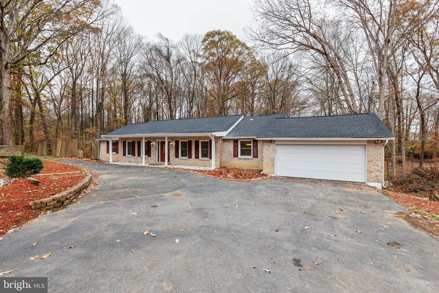 Open House Saturday from 11-1pm and Sunday from 11-3pm! Price Adjustment! Welcome home to a gorgeous completely remodeled (over $224,000 in updates) oversize (4,043 sqft) five bedroom (two primary bedrooms with ensuites) four full bathroom home with one level living on the main level (2,027 sqft) and fully finished walk-out basement (2,016 sqft) that easily accommodates another family or au pair with family. This home backs to woods and has a small stream located on the nearly one acre park like setting. Walk in the spacious main foyer to all hardwood floors on the open concept main level. The entryway flows into the family room with a custom ledger stone fireplace, spacious living room with windows providing plenty of natural light, and an extra large dining area. The gourmet kitchen with a full island leads to the dining room and family room on the main level. The entire back side of the home provides views to the back yard complete with fire pit, trees, and small stream. The gourmet kitchen has all stainless steel Samsung appliances, oversized refrigerator, a range hood that vents to the outside of the home, and premium corian countertops. The cooktop is WIFI capable. In addition, there are two butler pantries for your coffee bar and entertaining. The main level has three large bedrooms and separate full bath with the primary bedroom having its own ensuite with a jacuzzi tub and walk in shower. In addition, there is a generous two car garage. The walk out basement has a primary bedroom with ensuite that has a jacuzzi and walk in shower. The fifth bedroom is located in the lower level and has access to a private full bathroom. The basement has a complete kitchen space with sink, recreation room, second family room, potential office, and exercise rooms. The laundry room has a newer Samsung washer and dryer. New roof and energy efficient windows in the home. Generator sold "As Is". Nearby community pool, golf course, tennis courts, and walking/jogging paths. Perfect location for Quantico Marine Base, Fort Belvoir, Pentagon, Arlington, and DC.