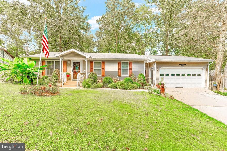 This 3 bedroom rambler has a spacious two car garage with work shop, lots of storage shelving, pull down attic storage and a half bath! Inside the main house you will find a traditional floor plan with open eat in kitchen and laundry, three bedrooms including main bedroom with large walk in closet, family room, and a sun room with cathedral ceiling overlooking the fully fenced back yard. Nice multi level rear deck for enjoying nature, morning coffee and bird watching plus your own little fish pond. Newer hvac, concrete driveway. Access to a private  beach is walking distance from the house. Enjoy the ease of having it all on one level