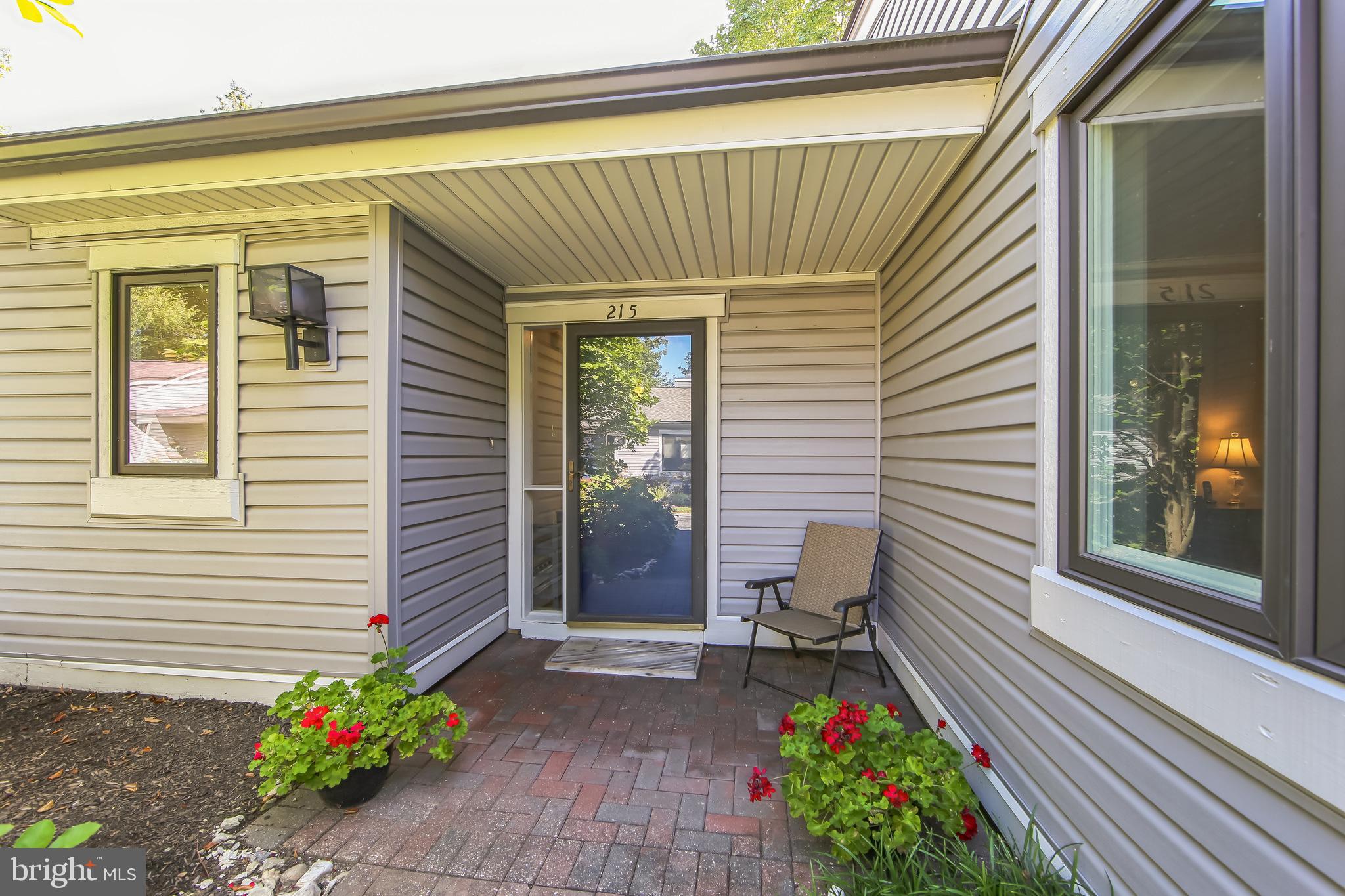Welcome Home to this well maintained Goshen Model in Brighton Village. This floor plan is very popular due to having two primary suites, each with their own private en suite bath and walk-in closet. (Ideal for hosting family and guests). This home has a flat entryway (which is a must for some). The Kitchen has Laminated Wood Flooring, Corian Countertops, Recessed Lighting, Newer Windows and is a neutral color. The Dining Room has laminated wood flooring, newer windows and a newer slider leading to the outside Brick Patio. The Living Room also has laminated wood flooring, a cathedral ceiling, wood burning fireplace , and offering an abundance of natural light. The Bedroom closest to the Kitchen has gray carpeting, newer windows, a window seat and ceiling fan. The Bathroom has a tub/shower combination , a one-sink vanity and walk-in closet. The other primary suite has gray carpeting, newer windows and a walk-in closet. The Bathroom has a walk-in shower ( tiles have been replaced ) and a one-sink vanity. Key features to this home are: New HVAC, New Hot Water Heater, Newer Windows throughout, New Siding (2023) and New Roofs (2022). . Hershey's Mill is a highly sought after 55+ active community with so many amenities (pool, tennis, pickle ball, walking trails, library, the gardens, etc.). Membership at the Hershey's Mill Club is also available with an added membership fee. Come make this home yours. Note: Seller is asking that settlement be scheduled after October 14, 2025.