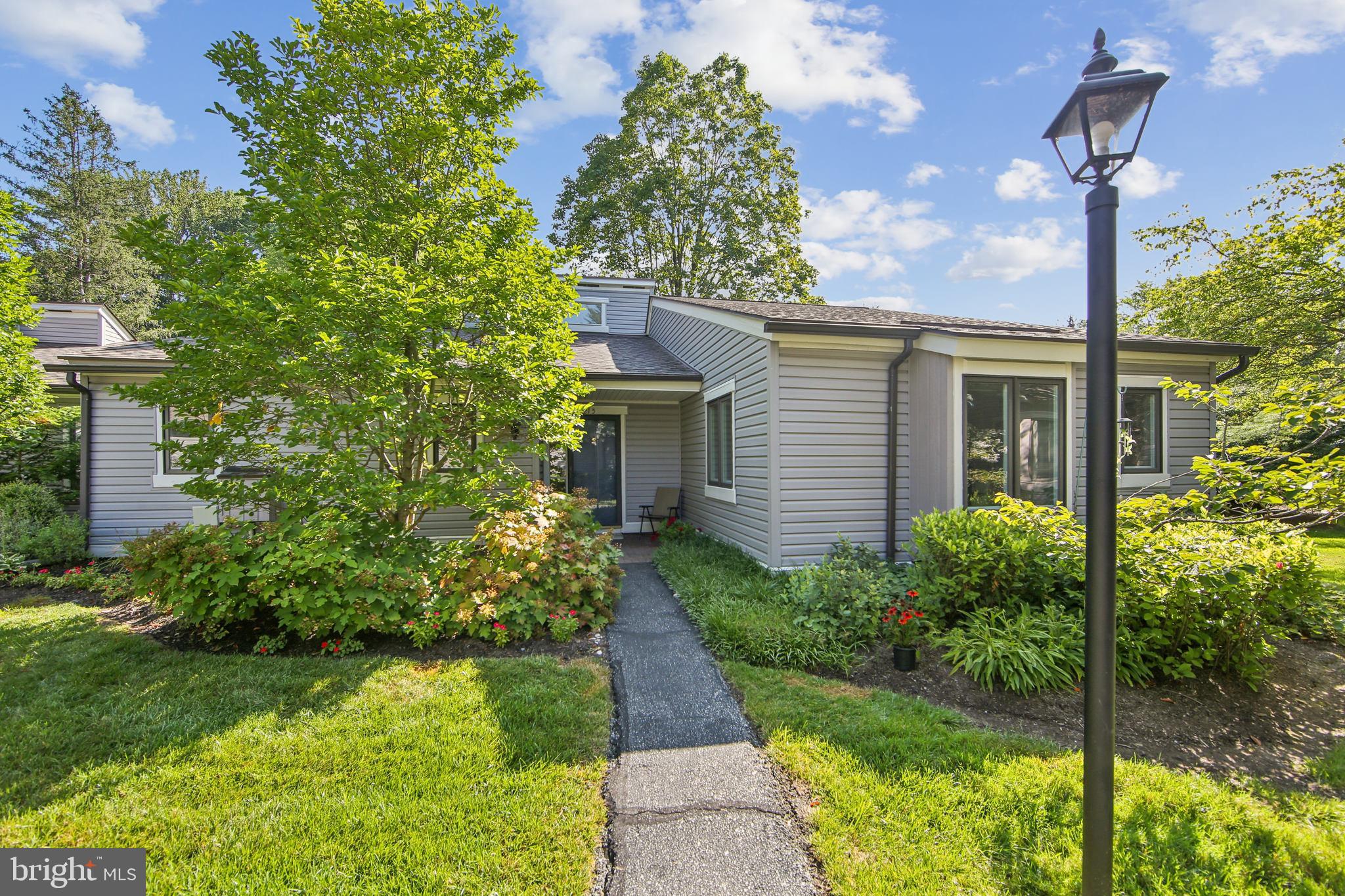 Welcome Home to this well maintained Goshen Model in Brighton Village. This floor plan is very popular due to having two primary suites, each with their own private en suite bath and walk-in closet. (Ideal for hosting family and guests). This home has a flat entryway (which is a must for some). The Kitchen has Laminated Wood Flooring, Corian Countertops, Recessed Lighting, Newer Windows and is a neutral color. The Dining Room has laminated wood flooring, newer windows and a newer slider leading to the outside Brick Patio. The Living Room also has laminated wood flooring, a cathedral ceiling, wood burning fireplace , and offering an abundance of natural light. The Bedroom closest to the Kitchen has gray carpeting, newer windows, a window seat and ceiling fan. The Bathroom has a tub/shower combination , a one-sink vanity and walk-in closet. The other primary suite has gray carpeting, newer windows and a walk-in closet. The Bathroom has a walk-in shower ( tiles have been replaced ) and a one-sink vanity. Key features to this home are: New HVAC, New Hot Water Heater, Newer Windows throughout, New Siding (2023) and New Roofs (2022). . Hershey's Mill is a highly sought after 55+ active community with so many amenities (pool, tennis, pickle ball, walking trails, library, the gardens, etc.). Membership at the Hershey's Mill Club is also available with an added membership fee. Come make this home yours. Note: Seller is asking that settlement be scheduled after October 14, 2025.