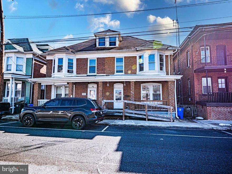 Beautiful brick end unit home with original hardwood floors throughout the main level. This home features fresh paint and large rooms with tall ceilings, 3 bedrooms and 1 bath.  Rear parking with spacious backyard, deck and patio.