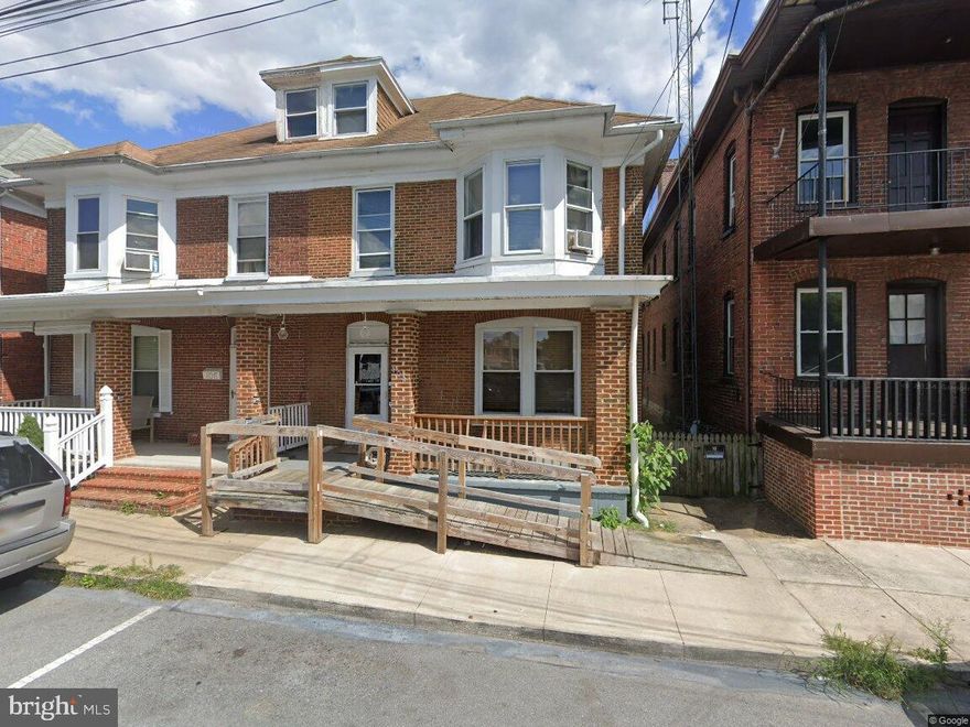 Beautiful brick end unit home with original hardwood floors throughout the main level. This home features fresh paint and large rooms with tall ceilings, 3 bedrooms and 1 bath.  Rear parking with spacious backyard, deck and patio.