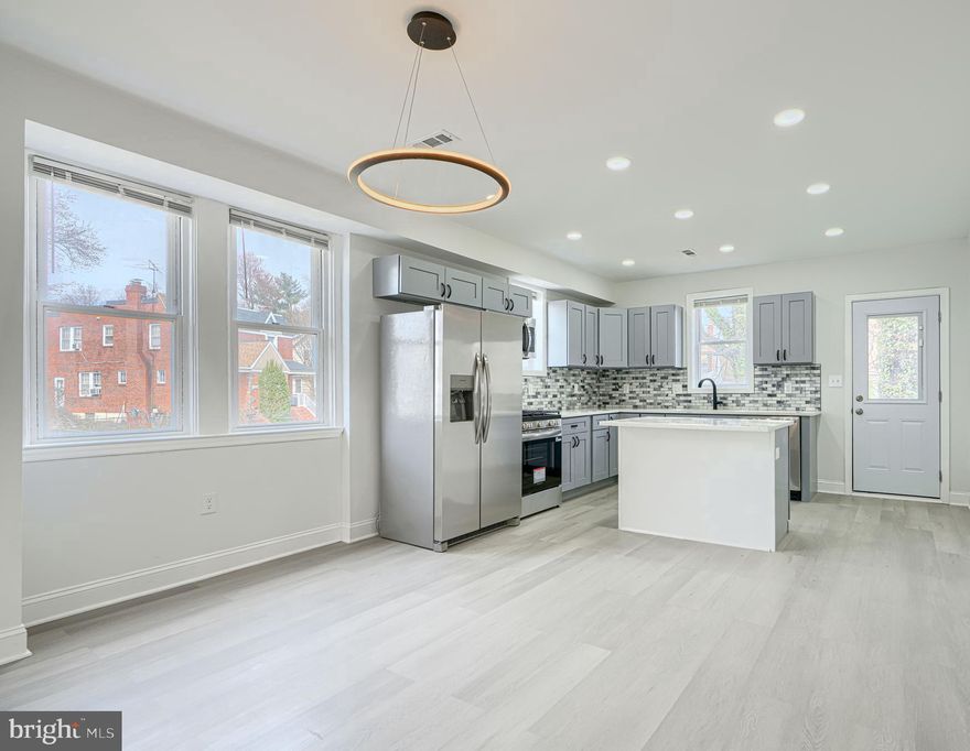 Wake up every morning, and say, I can’t believe I live in this amazing home! Corner lot! Open layout! Gorgeous kitchen with Quartz countertop and island,  coordinating backsplash, wood shaker cabinets, and stainless steel appliances. Upstairs dual entry bath is elegant and comfortable, with custom tilework and designer plumbing and lighting fixtures. Fully finished basement features a family room and 4th bedroom which has a private full bathroom with custom tile shower. This home has a front porch, and a deck, fenced in back yard, coordinated lighting and plumbing fixtures, new doors interior and exterior, recessed lighting, new HVAC system, Luxury vinyl plank flooring. Baltimore City permits and inspections. You will love this home.