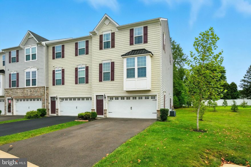 Nestled in the charming Perkasie Woods community, this delightful end-of-row townhouse offers a perfect blend of modern comfort and traditional style. Built in 2017, this home features an inviting open floor plan that seamlessly connects the living, dining, and kitchen areas, making it ideal for both entertaining and everyday living. 
The heart of the home is the spacious kitchen, complete with a stylish island and stainless steel appliances, including a built-in microwave (vented outside), gas range, dishwasher and newer (2024) refrigerator. The kitchen features upgraded cabinets and countertops, and a convenient pantry provides ample space for your storage needs. The warm wood floors throughout the main level add a touch of elegance and warmth. Step outside to your private deck, which overlooks woods and open space, offering a serene perch ideal for morning coffee or evening gatherings.
Retreat upstairs to the serene primary suite, which boasts a luxurious soaking tub, dual-sink vanity and a separate walk-in shower in the en-suite bathroom, providing a perfect escape after a long day. Two additional bedrooms offer ample space for guests or a home office, with a full shared bath off the hallway. Enjoy the convenience of the second-floor laundry, making chores a breeze.
The fully finished lower level provides extra living space, perfect for a playroom, home gym, or media room. With a third full bath on this level, there is the potential for use as a guest space or possibly a 4th bedroom. There is a walk-out door to a covered patio for additonal outdoor living space. The hot water heater was installed July 2025. With an attached garage, driveway parking and an overflow parking lot, you'll never have to worry about finding a spot.  This home is not just a place to live; it's a place to create lasting memories.
Located within walking distance of downtown Perkasie, shopping, dining and parks, this home offers the perfect blend of small-town charm and convenience!