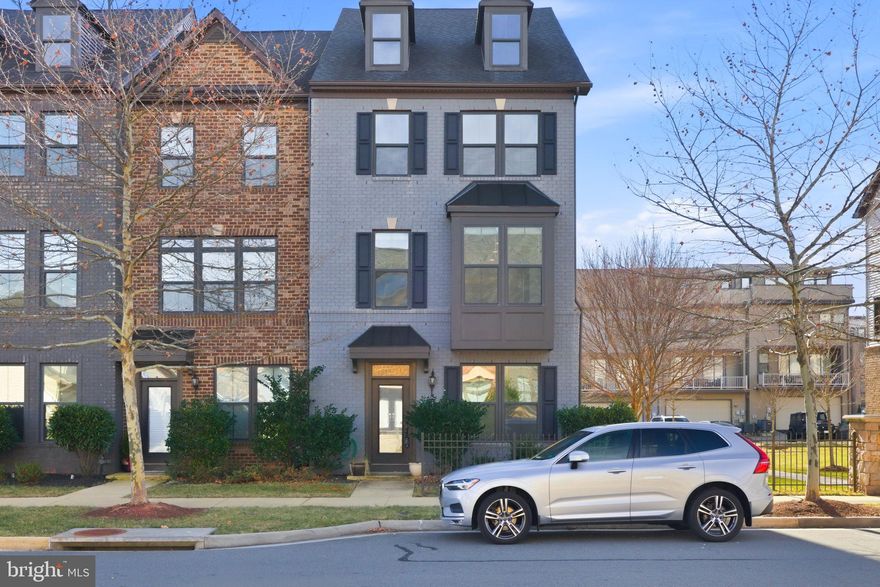 Welcome home to Westmore at Moorefield. This is a rare opportunity to own a truly modern corner-unit townhome located less than one mile from the Ashburn Metrorail Station and just minutes from the Dulles Toll Road.

Offering 4 bedrooms and 3.5 bathrooms, this home features a thoughtfully designed, contemporary layout. The entry level includes a private bedroom and full bathroom—ideal for guests or a home office—along with a convenient rear-entry garage.

The main living level showcases an open-concept design perfect for both everyday living and entertaining. The gourmet kitchen is the centerpiece, featuring a large island ideal for bar seating, stainless steel appliances, a double wall oven, cooktop, and ample cabinetry. Separate dining and living areas provide flexibility, while the enclosed balcony off the living room offers a perfect space to unwind.

Upstairs, the primary suite serves as a true retreat with an en-suite bath highlighted by a spacious soaking tub. Two additional bedrooms share a well-appointed hall bathroom, offering comfort and functionality.

Set within an amenity-rich community and an unbeatable commuter location, this exceptional townhome blends modern design, convenience, and lifestyle—don’t miss your opportunity to call Westmore home.