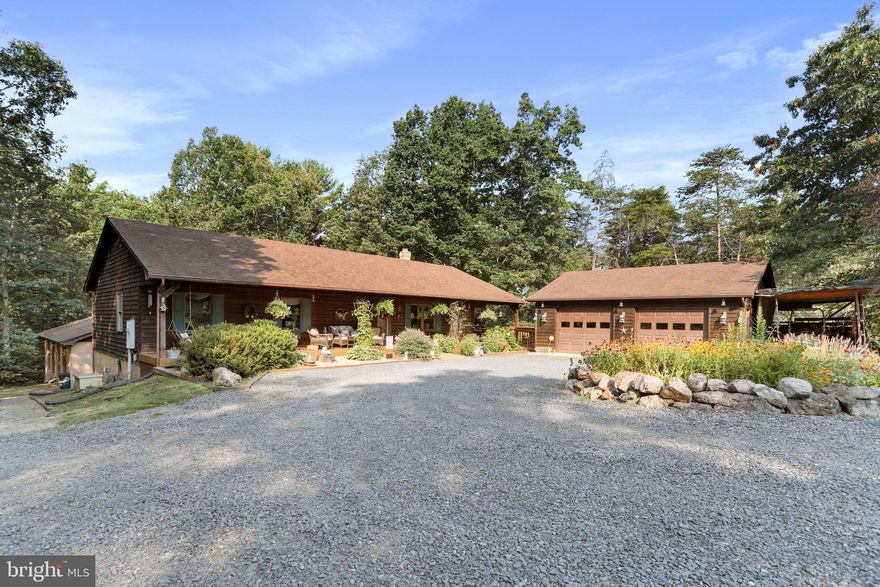 Amazing home in the mountains offering privacy and just a short 30 min drive to Winchester VA! This home's features include a Gourmet Kitchen with industrial stainless appliances, double wall oven, built-in microwave, gas cooktop, and plenty of storage! Island and room for a table in the breakfast nook area! Spacious Family Room with stone gas fireplace, Main level Primary Owner's Suite with sitting room and an additional stone fireplace which is double sided to add a cozy environment in the luxury bath with soaking tub, stall shower, and walk in closet! Formal Dining Room on main level. Lower level has a second kitchen area, large recreation room, exercise room, home office, and two additional bedrooms. *HEATED INDOOR SWIMMING POOL!!* 3 detached garages offering 6 parking spaces with garage door openers as well as a workshop space! Relax and enjoy your private escape on the patio, front porch or wood deck! This home HAS IT ALL!