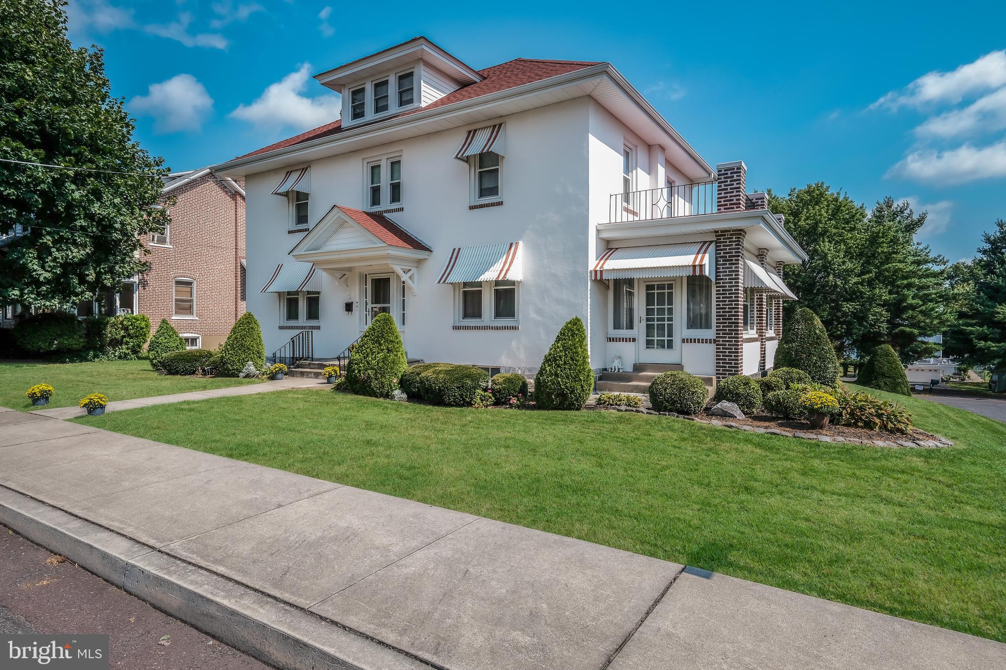 A stately 1927 center hall colonial, with 3 bedrooms, 1-1/2 baths and so much charm, located in the heart of Perkasie Boro. You'll fall in love with all the character that makes this home so special including all the marble window sills from Italy. The living room, with hardwood under the carpet, has a parlor feel and is spacious in size. Off the living room is a heated conservatory with 2 entrances full of natural lighting. The formal dining room has beautiful built-in cabinets to display your favorite pieces, as well as plenty of storage behind. The kitchen has been updated to include new cabinets, countertops,  and under cabinet light. Enter onto the large covered back porch, to enjoy the seasons of the wonderful backyard. Let's go upstairs where you'll find an owner's bedroom with a bonus room and a door leading to a private balcony. Two additional bedrooms and full bathroom compliment the 2nd floor, including an enclosed 3 season sunroom off the 3rd bedroom. Hardwood flooring is under some of the carpets in the bedrooms. There's more! The walk-up 3rd floor attic offers much storage and closets. Certainly space to be finished if you so desire and would make a fun game room. Heading downstairs into the basement you'll find the laundry room with laundry sink, room for a workshop, lots of storage and more closets. Enter the oversized one car garage from the lower level. Some of the updates in 2013 included a new roof, gutters, all new window and a new boiler. 3 new storm doors in 2016, as well as the front door being restored. Please take note of the detail including the hand painted mural at the staircase landing, leading upstairs. Another special feature is the elevator leading to all 3 levels (though seller is not making any representation to its present condition.) This home is situated on an ideal corner lot with mature landscaping all around.