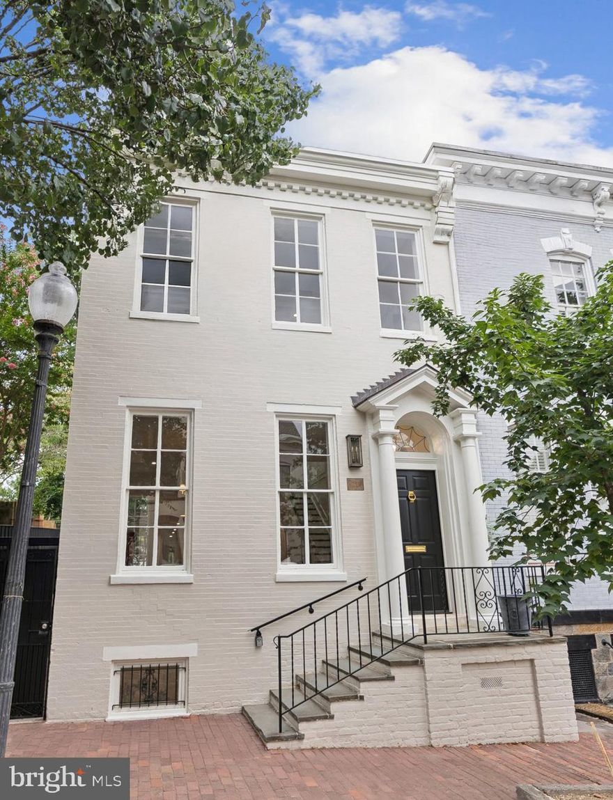 IMMACULATE NEW RENOVATION IN GEORGETOWN’S EAST VILLAGE! Welcome to 1219 29th Street, where every inch of this residence has been rebuilt to perfection by RG Custom Builders and finished with bespoke interior design by Edith Gregson Interiors. This exquisite custom-built 4 Bedroom, 3.5 Bath home spans nearly 3,500 SQFT across 3 stories of open living space flooded with an abundance of natural light and luxury finishes. Step inside to discover the expansive ceilings, custom arched doorways, crown molding, White Oak hardwood floors, designer lighting, gourmet Kitchen with custom Taj Mahal Honed Quartzite Kitchen counters and backsplash, Shiloh Inset custom cabinetry, and top-of-the-line Wolf & SubZero Kitchen appliance package. The Main Level features an open floorplan offering a gracious formal Living Room with gas fireplace and restored mantel with marble hearth and marble inset. The Main Level also features a luxury Kitchen, Dining area overlooking the deep rear gardens, and Powder Room finished with custom honed granite vanity and Schumacher designer wall-coverings. The Upper Level features the Primary Suite, 2 additional Bedrooms, a second Bathroom and convenient Laundry Room. The Lower-Level presents versatile possibilities with a Guest Suite offering a gracious Bedroom and Full Bathroom, second Laundry Room, and a spacious second Living/Family Room complete with wet bar, beverage cooler and ample storage. Retreat outdoors to your very own, serene private garden with hardscape patio – the perfect oasis for entertaining or relaxing after a long day. This meticulously upgraded residence has been thoughtfully redesigned for modern living while honoring its Georgetown heritage.