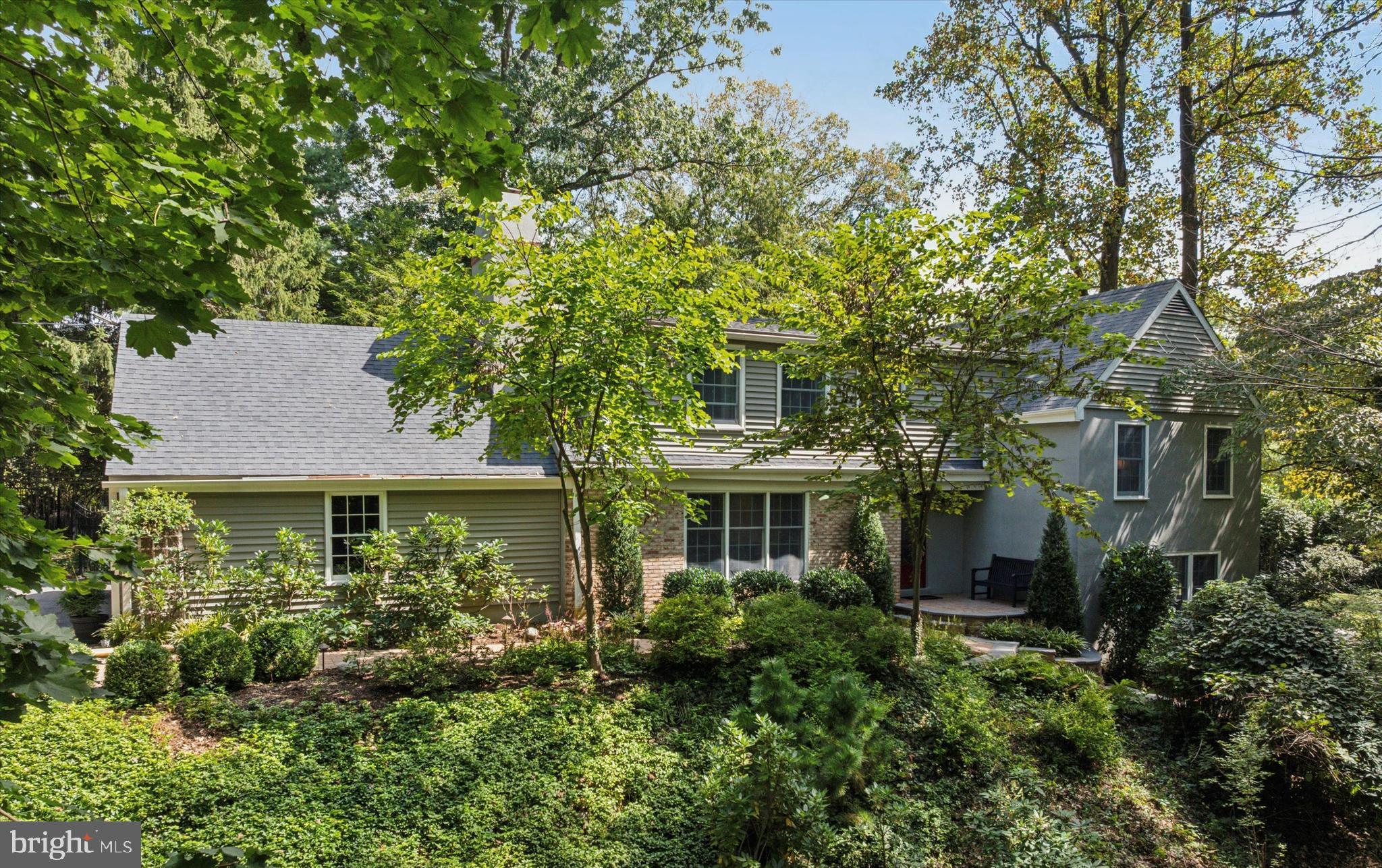Welcome to 103 Deepdale Road. Located in one of the Main Line’s most desirable neighborhoods, this brick and siding split level offers 3,138 square feet of luxurious living space, five bedrooms, three full and one-half bathrooms, a two-car side entry garage, screened in covered porch, and a 1.7-acre lot, seamlessly blending functionality and privacy. The main level includes a welcoming entrance foyer with coat closet, living room with built-in shelves and wood burning fireplace, and a dining room with crown molding and a slider to the covered porch. The highlight is the gourmet kitchen featuring white cabinetry, a center island with seating, stainless steel appliances, quartz countertops, and overhang seating for four. The first upper level includes the primary bedroom suite with a full bathroom and two closets, a large secondary bedroom with double door closet, and a recently renovated full hall bathroom with subway tile surround, tile floor, and shiplap accent walls. The next level up has three spacious bedrooms and another recently renovated full hall bathroom with white subway tile shower surround and glass shower enclosure. The walkout lower level has a family room with tile floor, built-in shelves, and a double French door to the rear paver patio, a half bathroom, and a partially finished area with laundry and storage. Other highlights include hardwood floors throughout most of the main and upper levels, newer roof (2017), newer kitchen appliances and countertops, screened-in covered porch with ipe hardwood floors, vaulted ceiling, and exposed beams, Anderson windows, and newer paver walkway with steps leading to front door and rear yard. The home overlooks a 1.7-acre wooded lot with mature oak and maple trees, leading down to a small creek. It’s a perfect spot for kids to play outdoors, build forts, roast smores, and explore nature. All while being conveniently located close to all major commuter routes, shopping, dining, downtown Wayne, King of Prussia and is part of the top rated Tredyffrin-Easttown School District. Deepdale is a close-knit community known for its strong neighborhood association and family friendly events. Enjoy walking to the Strafford Train Station, Strafford Library, and Strafford Park.