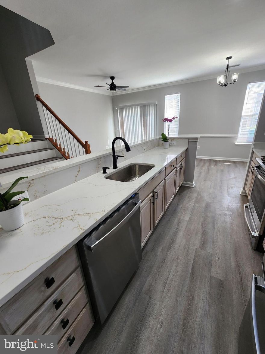 Completly renovated!! Kitchen has new GE Stainless steel appliances: French Door refrigerator, slide in stove, and quiet dishwasher. Kitchen has new Calcutta Gold counter-tops. New vinyl plank flooring on 1st level and stairs. Bathrooms have new Calcutta  gray tile,  and new vanities. New light  fixtures and new plumbing throughout house. New carpet in bedrooms.