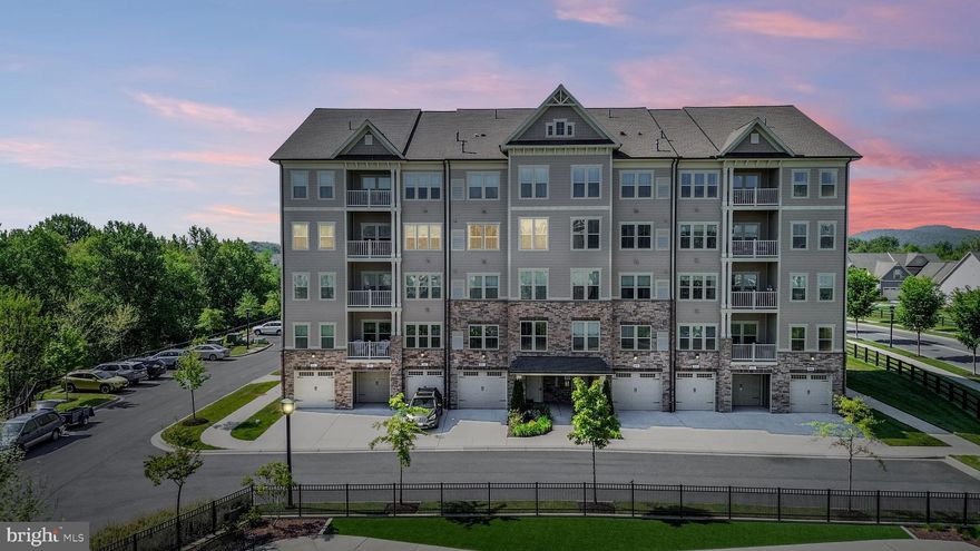 Wow! This luxury condo in the highly sought-after 55+ Woodlands of Urbana neighborhood features a rare and hard-to-find upgrade in these condos—a bonus bump-out space with a custom built-in desk and shelving that makes for the perfect office or craft room! This meticulously maintained home offers comfort and ease of living, and keeping organized is easy with custom California Closets shelving systems installed throughout the home! Upgrades include automated blinds in the living area and ceiling heaters in the bathrooms! As you enter, you'll be greeted by high ceilings, abundant recessed lighting and an upgraded dining room light fixture–filling the space with warmth and style. The open-concept floor plan flows seamlessly from the living and dining areas to the gourmet kitchen. Cook in style with upgraded granite countertops, a large center island with breakfast bar, upgraded stainless steel appliances, a custom tile backsplash, bottom cabinet pull-out drawers and 42-inch cabinets. Step outside from the living area to your private balcony with great views overlooking woods and neighborhood amenities. Relax in the spacious Primary Bedroom Suite, featuring a walk-in closet with built-in closet organizers and another large closet with custom shelving. In the spa-inspired Primary bath, you will find dual vanities and a custom-tiled shower with a built-in bench as well as a separate linen closet for added storage. The second bedroom features dual closets, the light-filled upgraded bump-out bonus space and an en suite bathroom featuring a custom tile tub/shower combo with additional hall access for guests. Enjoy the convenience of an in-unit washer and dryer, and an always-ready tankless hot water heater. Need extra storage space? The foyer features a coat closet and an oversized storage closet with built-in shelving.  The oversized one-car garage was professionally painted and provides space for your vehicle and additional storage needs. Access the elevator from your garage via a short hallway. Living in The Woodlands means you're not only getting an incredible home but also a fantastic community with unmatched amenities. The neighborhood is conveniently located near all of the great features of Urbana, including a Market Center with a grocery store, restaurants, the library,  senior center, doctor’s offices, and multiple parks--making it easy to enjoy everything the area has to offer. The amenities within the neighborhood are truly exceptional--and include a pool, fantastic clubhouse with a billiards and poker room, extensive gym, yoga/exercise studio, golf simulator, and meeting rooms for the myriad of community activities. Plus, you can enjoy walking trails, pickleball, bocce courts, dog parks, firepits, a putting green and the herb garden! The community is extremely active, and there are plenty of activities to keep you busy. Whether it's playing pickleball, bocce, croquet or Mahjong with friends, attending seminars, or taking part in other activities, you'll always have something to do. The Woodlands is the perfect place to meet new friends, enjoy an active lifestyle, and create lasting memories. One of the best perks of living in The Woodlands is that you can spend your time doing what you love instead of worrying about maintaining your lawn, mulching, or shoveling snow. The HOA takes care of all of that, so you can focus on enjoying your free time. Don't miss your chance to experience the incredible amenities and active lifestyle of The Woodlands—schedule your showing today!