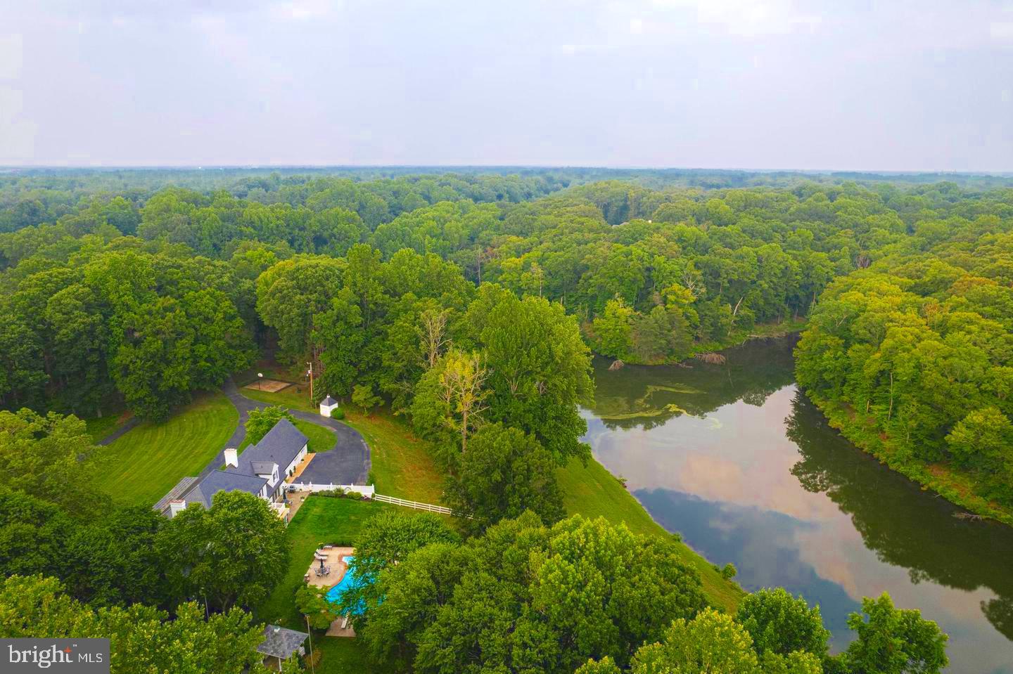 Welcome to Cool Springs Farm, a peaceful and serene 81 acre property with its own private lake. This extraordinary Southern Maryland Georgian style estate includes both a main level and upper level primary suite, a beautiful in ground pool with stunning views, and a lighted tennis/pickleball court. The total 81 acres consists of 2 lots and you can build an additional home on the 75 acre parcel as part of the entire property.
This private retreat feels far from it all but it’s only minutes from downtown La Plata, and less than an hour drive to downtown DC (30 miles).