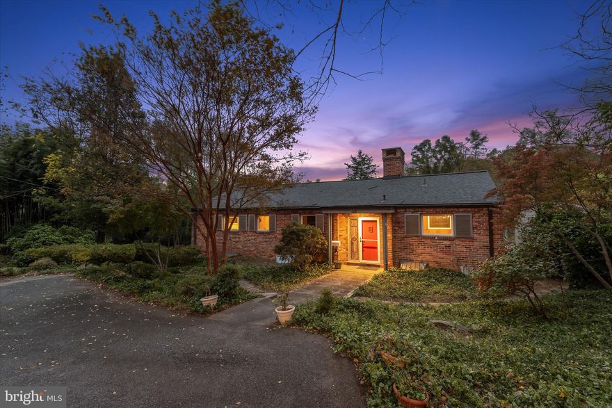 Tucked away on nearly an acre of lush land in the heart of Bethesda’s sought-after Green Acres neighborhood, 5311 Allandale Road offers a rare blend of mid-century modern character, privacy, and convenience. Whether you choose to move right in and enjoy this one-of-a-kind home or expand and bring your vision to life, the possibilities are endless. Surrounded by mature trees and tranquil landscaping, this distinctive four-bedroom, two-and-a-half-bath residence provides a true retreat just minutes from downtown Bethesda and Washington, D.C. Step inside to discover a warm and inviting interior filled with natural light, where hardwood floors, hand-laid brick walls, and wood accents highlight the home’s authentic 1950s craftsmanship. The main level features a large family room with a wood-burning fireplace and a built-in desk. The primary bedroom suite boasts two closets and a private bathroom with a walk-in shower. Two additional bedrooms and a second full bathroom complete this level, all enjoying serene wooded views from oversized windows. Downstairs, the finished lower level is designed for flexible living. It includes a fourth bedroom, half bath, and a spacious open-concept living and dining area anchored by a striking stone fireplace wall. The kitchen features granite countertops and backsplash, lighted cabinetry, a pantry, and direct access to the stone terrace that is ideal for outdoor dining or quiet relaxation. A large laundry room and a versatile bonus room, perfect for a workshop, studio, or greenhouse, add even more functionality to this level. Outside, winding stone walkways and mature landscaping create a peaceful backdrop for everyday living, with an expansive backyard ideal for outdoor activities. Enjoy easy access to trails, shops, restaurants, Metro, and top-rated schools. Explore the best of Bethesda living in the coveted Green Acres community, moments from Little Falls Swimming Club, the Capital Crescent Trail, and neighborhood parks. Ideally located near Friendship Heights Metro, shops, restaurants, and major commuter routes, this is a wonderful opportunity to make this peaceful retreat your own. Some images have been virtually staged.