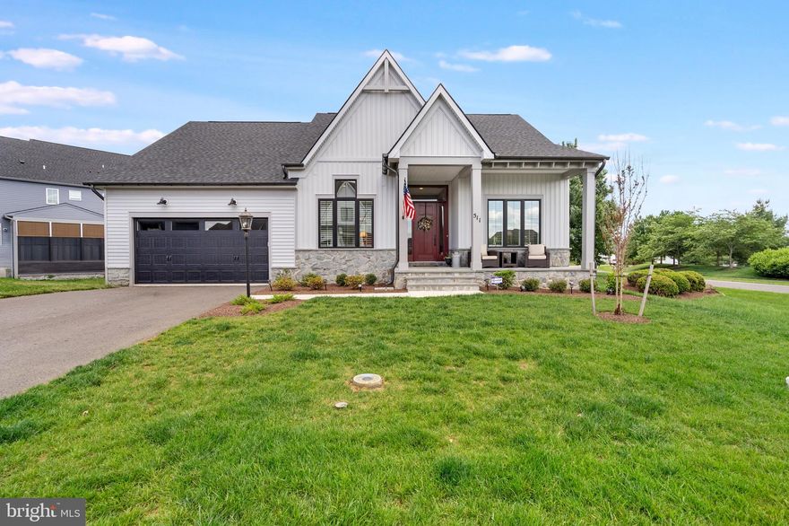 Welcome to this stunning award-winning Farmhouse Collection 2025 ranch style home located in the sought-after gated community of Bellair. This beautifully designed  home combines luxury finishes, thoughtful upgrades, and easy main-level living with an exceptional open-concept floor plan. From the moment you enter, you will appreciate the soaring ceilings, luxury vinyl plank flooring, and bright, welcoming foyer. A dedicated office with recessed lighting and LVP flooring provides the perfect work-from-home space. Beautiful plantation shutters installed throughout the home add timeless style and elegance. The gourmet kitchen is truly the heart of the home, featuring gorgeous marble countertops, a massive center island, farmhouse sink, stainless steel appliances, wall oven, gas cooking, and abundant cabinet space. The adjoining dining area showcases spectacular oversized sliding glass doors that flood the home with natural light and create seamless indoor-outdoor living. Step outside to enjoy the screened-in porch with Trex flooring and recessed lighting, which opens to a brand-new Trex deck with vinyl railings and steps leading to the backyard. The spacious living room offers a gas fireplace flanked by custom built-ins with marble tops and opens beautifully to the kitchen and dining areas, making this home ideal for entertaining. The luxurious primary suite features an impressive custom-organized walk-in closet with extensive shelving and a spa-like primary bath with a marble double vanity, luxury vinyl tile flooring, and a walk-in shower. A secondary main-level bedroom includes carpet and its own private en-suite bath with beautiful ceramic tile flooring and a tiled tub shower. The finished lower level offers even more living space with a huge rec room, an additional carpeted bedroom, and another full en-suite bath with ceramic tile flooring and a tub-shower combination. There is also a large storage room complete with a passive radon system, sump pump, and water softener. Additional highlights include a two-car front-load garage, Hardi Plank siding, stone water table, and a gorgeous covered front porch. Residents of Bellair enjoy outstanding community amenities including a pool, walking trails, and HOA-maintained lawn care with mowing, mulching, and weeding included for low-maintenance living. Tucked away for peaceful everyday living, yet perfectly situated for commuters traveling to Maryland, Virginia, or Washington, D.C.