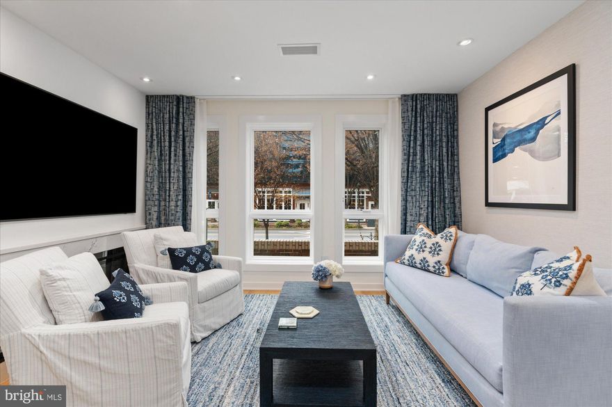 An Exceptional Downtown Bethesda Residence — A Private Urban Sanctuary

Tucked just steps from Bethesda’s finest shopping and dining, this extraordinary townhouse condominium offers a rare opportunity to own a fully renovated, fully furnished residence of uncompromising quality. Conceived and executed as a true pied-à-terre, the home blends sophisticated design with effortless livability—an oasis in the heart of one of Maryland’s most affluent neighborhoods.

The main living space is flooded with natural light through oversized Pella high-performance casement windows, creating an immediate sense of openness and calm. Anchoring the room is a striking 60” linear electric fireplace, framed in Cambria quartz. The tailored Knoll Textiles double-track draperies create an elegant focal point for both intimate evenings and refined entertaining.

The kitchen is nothing short of spectacular. Thoughtfully designed to balance beauty and function, it features exquisite cabinetry, Cambria Inverness Cobalt Luxury Series quartz countertops and full-height backsplash, and a curated suite of Liebherr, KitchenAid, and Bosch appliances. The open layout allows the host to cook with ease while remaining seamlessly connected to guests—perfect for both casual gatherings and elevated dinner parties.

Adjacent to the kitchen, the dining area is a masterclass in intelligent design, featuring built-in banquette seating with hidden storage beneath and a dramatic Jax Sputnik chandelier overhead—an inviting space that feels both intimate and architectural.

Upstairs, the primary bedroom unfolds as a serene retreat, seamlessly integrating a dressing area with beautifully crafted cabinetry and a built-in desk—ideal for quiet mornings or discreet work-from-home moments. The spa-inspired primary bath is sleek and indulgent, offering a floating dual-sink vanity, Origami White wall tiles, heated tile flooring with programmable thermostat, and recessed medicine cabinets with magnifying mirrors—every detail considered, every finish elevated.

The bright lower level provides exceptional flexibility, functioning as a private guest suite or relaxed lounge. It includes extensive storage, a built-in U-Line beverage refrigerator, a discreet Resource Furniture Murphy bed, and a beautifully finished full bath—perfect for hosting overnight guests in complete comfort and privacy.

Outside, a secluded private patio offers a rare opportunity for alfresco moments—morning coffee, evening cocktails, or simply a quiet escape from the city’s energy.

Throughout the home, select white oak 5” engineered wood flooring, forged iron stair railings, a DSC security system with interior cameras, and a state-of-the-art professionally installed home network and WiFi system underscore the level of investment and attention to detail.

This is not merely a residence—it is a statement. A turnkey, design-forward sanctuary in downtown Bethesda, offering privacy, luxury, and walkable convenience in a package that is both rare and irreplaceable. For the buyer who values excellence, discretion, and lifestyle, this home is truly worth every consideration.