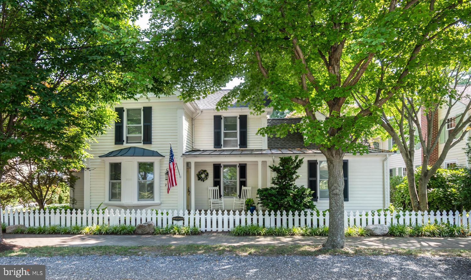 Discover the charm of 213 S Morris Street, an exquisite residence nestled in Oxford, MD's historic district. Originally built in 1870 by a skilled shipwright, this home was meticulously restored with a "down to the studs" renovation, seamlessly blending historic charm with modern luxury. The property boasts a gated brick and river stone driveway, providing off-street parking. The property is fully enclosed by both a historic brick wall and an Oxford-style picket fence ensuring privacy. The grounds are professionally landscaped and irrigated for natural beauty and feature a large blue slate patio for outdoor living. The home features a separate heated and air-conditioned studio/office, perfect for creative pursuits or remote work. Inside, the beautifully decorated interior offers a primary bedroom (with en-suite bath) on the first floor and three additional bedrooms upstairs. With three bathrooms—including two on the second floor, one on the first, plus a powder room—comfort and convenience are paramount. Enjoy cozy evenings by one of the four gas fireplaces or entertain in the stunning family room with vaulted ceilings and clerestory windows that adjoins a gourmet kitchen equipped with a six-burner Wolf stove and top-of-the-line appliances. The home is bathed in natural light, with top-quality windows and doors, and features pristine pine floors throughout. It's a "happy house," radiating warmth and elegance, and its reproduction costs in today's market would far exceed the list price.
