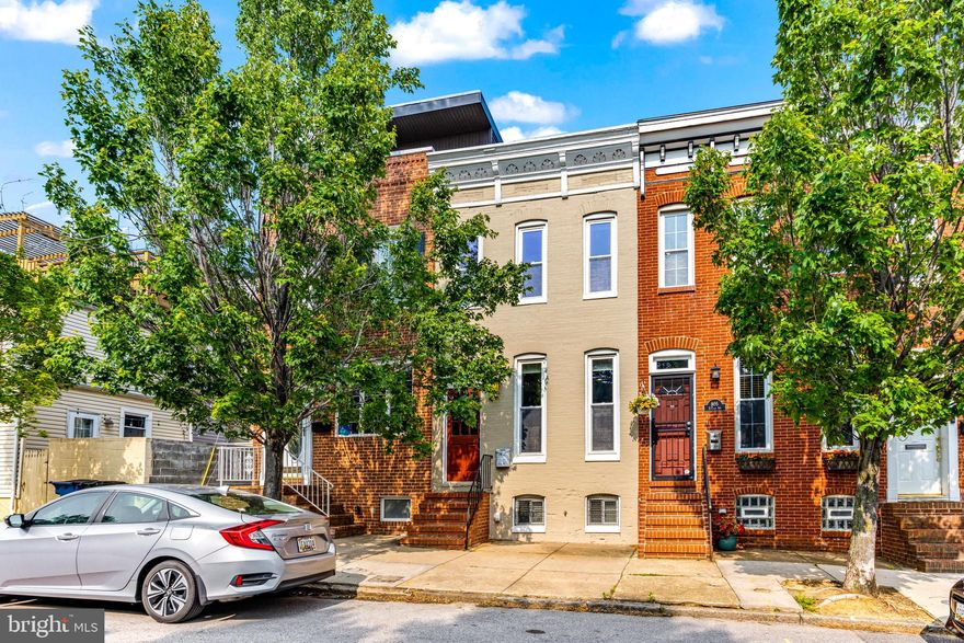 Looking for "Baltimore Charm"? This 3 bed, 3.5 bath townhome right in the heart of Canton is showcased 
 by its exposed brick through most of the house, rooftop deck with great views & it's own parking pad. Walk into your large livingroom with hardwood floors & recessed lighting, leading to a beautiful kitchen with stone counter tops, stainless steel appliances, more hardwood flooring and a half bath tucked away in the back of the house. Upstairs you have 2 beds & 2 full baths. In the primary suite you have more exposed brick, hardwood floors , a large closet & a full bath with a glass shower door. Roof and rooftop deck are only 4 years old. Finished basement with rare 8ft ceilings another bedroom & full bath downstairs. This is a truly charming property that offers just about anything you could want, so schedule your showing to come see for yourself!