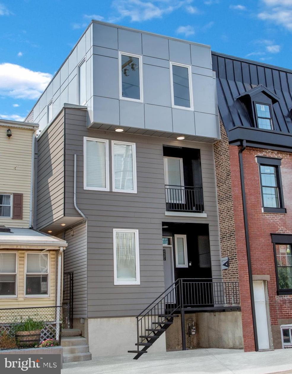 Welcome to 1214 E Fletcher Street, a stunning oversized new construction home offering a two-story foyer, family room, multiple outdoor spaces, and a FULL 10-year Tax Abatement. Nestled in the heart of Fishtown, just steps from the La Colombe Flagship and vibrant Frankford Avenue, this home - located on a quiet side street - is a rare gem with approximately 3,600/SF of living space. As you enter through the impressive Two-story Foyer, you'll encounter an L-shaped staircase leading to the second floor on the right, while a spacious powder room and large coat closet adorn the left. The foyer guides you to the fully finished basement via one staircase and to the open-concept main floor flooded with natural light from European-style windows. The gourmet kitchen is a highlight with modern flat-panel cabinetry extending to the 9-foot ceiling, luxury stainless steel smart appliances, a wine cooler, and a large island with quartz countertops. The adjacent dining room and Two-story Family room, featuring six wall sconces, lead to a full-sized deck and backyard for delightful outdoor living. The second floor boasts two spacious bedrooms, a tastefully tiled modern bathroom, and a convenient laundry space. The primary suite on the third floor is a luxurious retreat with a grand bedroom, a walk-in closet, and a spa-like bathroom complete with a double vanity and a walk-in shower. The third floor also offers access to one of Philadelphia's largest terraces with unobstructed city views. The fully finished walkout basement provides additional versatile space, equipped with a sprinkler system. The house features Two-zone HVAC and Two water heaters. Indulge in a vibrant Fishtown lifestyle, offering an array of culinary delights such as W.M. Mulherin's & Son, Surraya, Kalaya, LMNO, Middle Child Clubhouse, and Pizzeria Beddia. Enjoy family-friendly activities with parks along the waterfront or the nearby Palmer Park. Embrace a healthy lifestyle with numerous gyms, juice bars, and local organic grocers. For those who commute, Fishtown provides unparalleled access to public transportation, major bridges, and highways, with the Market-Frankford "EL" Blue Line connecting to Center City and 30th Street Station for Amtrak travel to NYC, D.C., and beyond. Easy proximity to I-95, the Ben Franklin Bridge, and the Betsy Ross Bridge completes the convenience of this dynamic neighborhood. Don't miss the opportunity to own one of the finest homes in 19125. Square footage, taxes, and details are estimated, and buyers are encouraged to verify them independently. One of the owners is PA Real Estate Pro. Some of the photos were made with a virtual staging. Contact us for further information, and let's make this exceptional property yours.
