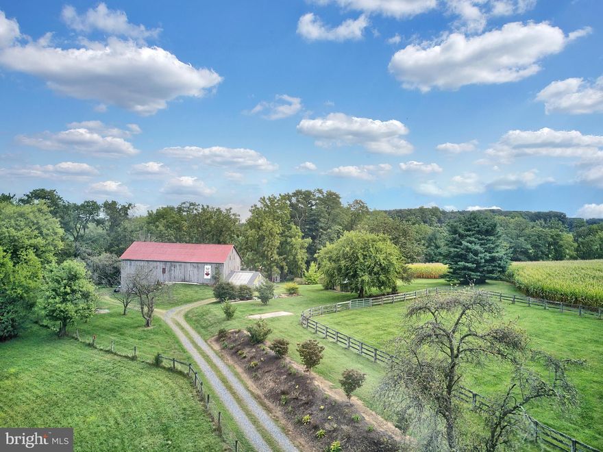 Beautiful and charming 7 bed/4 bath historic 50 acre farm available in Carroll County, with modern wing that was seamlessly added.  Lovingly maintained and cared for, with inviting rustic charm and amenities throughout, yet still offers blended modern conveniences as well. Enjoy the scenic views from bedroom balcony overlooking your very own stocked pond or enjoy your private theater room in the finished basement..  Included on the property is a wonderful and picturesque bank barn, as well 4 stall Morton building, cool temp greenhouse and a chicken house. This turn key farm is already set up for your horses, including fenced riding ring, tack room, 2 automatic pasture waters and fenced pastures.  This property really has something for everyone!