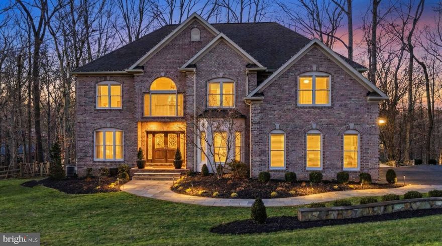 Welcome to this remarkable custom-built colonial home nestled on over an acre of beautifully landscaped grounds in the exclusive Patapsco Park Estates community of Ellicott City. Offering more than 5,600 square feet of finished living space, this home showcases exquisite craftsmanship, timeless design, and luxurious modern comforts. Step inside to find 6 spacious bedrooms, 5 baths, 3 car garage and impeccable finishes throughout. The gourmet kitchen is designed for both everyday living and entertaining, featuring professional-grade appliances, granite countertops, and rich custom cabinetry. The family room with coffered ceilings and a wood-burning fireplace flows seamlessly to the outdoor living spaces. The luxurious primary suite is a true retreat, complete with a private balcony overlooking the serene backyard, a spa-inspired bath and dual custom walk-in closets. The fully finished lower level offers additional space for relaxation or entertainment, including a guest suite with a full bathroom, media room, wine cellar, home gym, gas fireplace and custom built-ins. Enjoy the outdoors from the expansive composite decking, custom stone patio, indoor/outdoor stereo system and grill area, surrounded by mature trees for privacy. Located in the highly sought-after Mt. Hebron area of Howard County, this home offers the perfect blend of luxury, privacy, and convenience—just a short walk to Patapsco State Park and close to major commuter routes, shopping, and top-rated schools. Meticulously maintained and thoughtfully designed, this home is ideal for those seeking refined living in a peaceful setting. Conveniently located between Baltimore and DC, this residence is a centrally located, commuter-friendly suburb. Don't miss your chance to tour this magnificent home and make it yours. Schedule your appointment today!