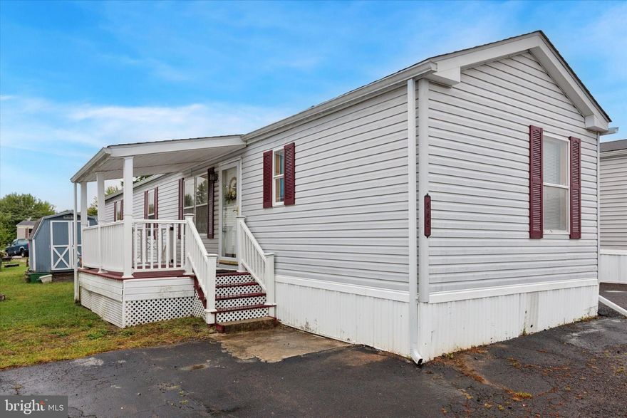 Welcome to 869 Buttonwood Ave!  Good size two bedroom and 2 full-size bathroom home. It is close to everything you need for daily life.  Easy one floor living. When you arrive, you will find one paved space for parking and a covered front deck, with a shed in the back of the home. As you enter you are greeted with an open living room and kitchen area. The refrigerator, stove, washer, and dryer are all included.  There are plenty of cabinets and storage in the kitchen.  There are nice-sized closets in both bedrooms. This home has central air.  Newer roof.  The new owner must be approved by the community.  Make your appointment today!!