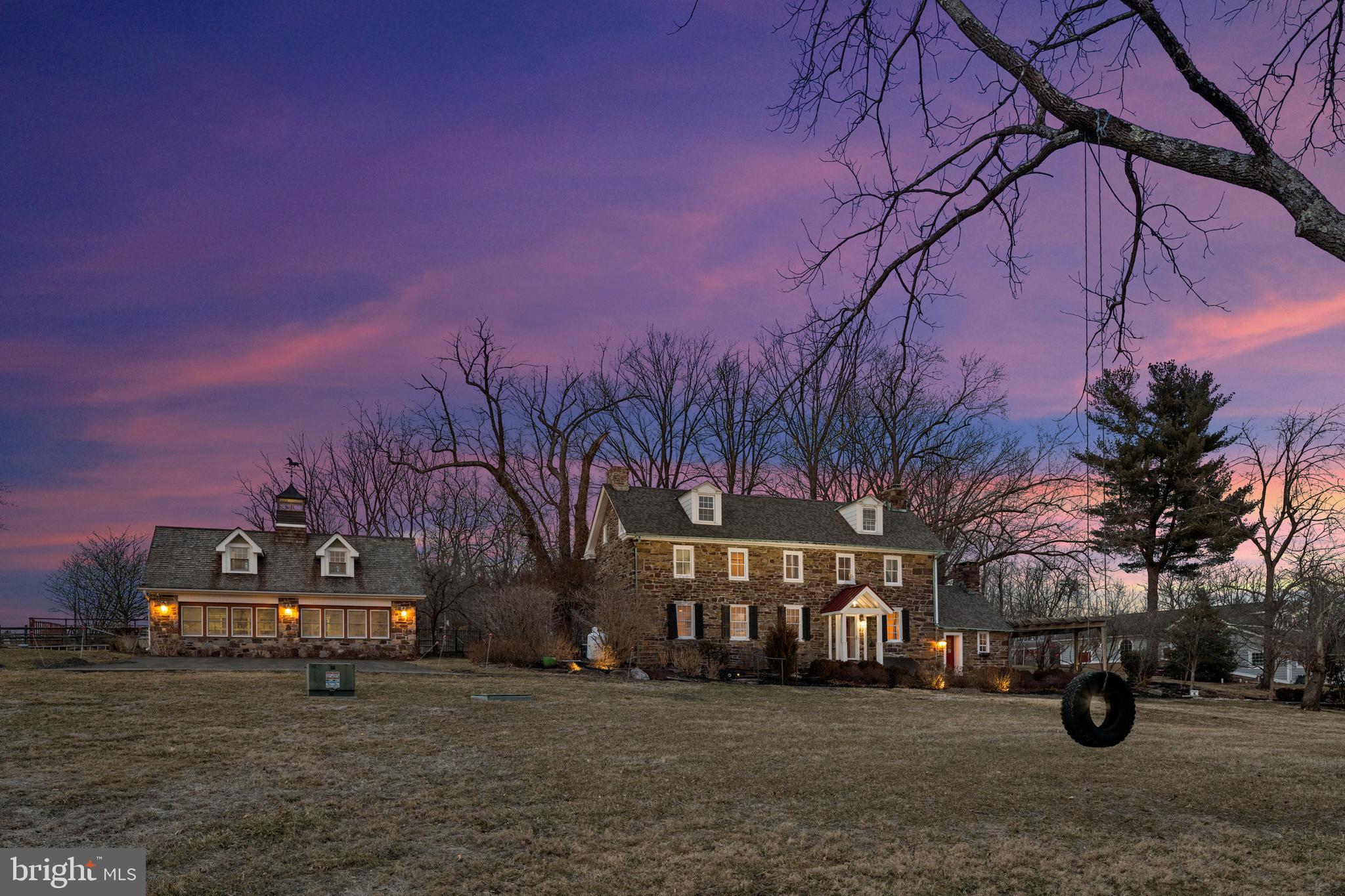 This magnificent equestrian estate, Fieldstone Farm, built in 1747, is an incredible CORNER LOT that stands on over 100 stunning acres in the heart of historic Bucks County. Steeped in rich history, Bucks County was first inhabited by the Lenape Indians and later settled by European colonists, including Swedes, Dutch, and Quakers. The area played a crucial role during the Revolutionary War, with George Washington launching his famed crossing of the Delaware from its banks. This estate, including a beautifully restored stone farmhouse and guesthouse, seamlessly blends 18th-century charm with modern luxury. The main house boasts 5 bedrooms, a custom gourmet kitchen, and 3.5 baths, offering a retreat for the most discerning buyer, gentleman farmer, or equestrian. The main residence, enhanced by skilled renovations and modern touches, preserves the unique architectural details of the era. The 1782 date stone on the property's cottage bears the initials A (Adam), C (Charity), and B (Barr), hinting at the involvement of Charity Barr during Adam’s military service in the Revolutionary War. The estate once flourished as a bustling agricultural hub, complete with cider works, stills, orchards, and barns. This exceptional home features three stunning fireplaces, each adding warmth and character to its beautifully curated spaces. The original walk-in fireplace, now transformed into a charming sitting area, provides the perfect setting to unwind with craft cocktails in a space steeped in history. The dining room showcases a magnificent fireplace with its original mantel, creating a refined and inviting atmosphere for elegant gatherings. In the graciously sized living room, another fireplace is complemented by original built-ins, blending function with timeless style. Just off the kitchen, the laundry/mudroom is a standout feature, boasting custom-built storage that enhances both convenience and sophistication.
The 1782 carriage house/guesthouse, includes a designer kitchen, dining room, great room with a stone fireplace, 2 bedrooms and full bath.
Outbuildings, such as a stable, outdoor riding ring, and a climate-controlled garage, cater to equestrians and car enthusiasts alike. Additionally, a 2.5-acre buildable lot provides space to expand and create your vision. This exceptional property marries history with modern elegance, reflecting both the heritage and beauty of Bucks County.
The farm is also part of Bucks County history: Set amidst the picturesque pastoral landscapes of Buckingham Township, Pennsylvania, Fieldstone Farm spans 103 acres of equestrian beauty and historic charm. Dating back to 1747, this 18th-century stone estate encapsulates the region’s deep-rooted history, tracing its origins to the Morrey family, whose legacy includes Humphrey Morrey, Philadelphia’s first mayor appointed by William Penn. Through the centuries, this estate has witnessed transformations under multiple owners, from the Barr family—who expanded its agricultural prominence and historic structures—to notable subsequent caretakers such as the Rittenhouse and Foster families.
By the 20th century, Fieldstone Farm saw a variety of changes, from ownership by European immigrants to its eventual showcase as the 2010 Bucks County Designer House and Gardens, showcasing the dedicated work of designers who revived its interiors and exteriors. Today, Fieldstone Farm remains a testament to Bucks County's rural past, enriched by layers of history and a panoramic view that reflects the timeless beauty of its surroundings.