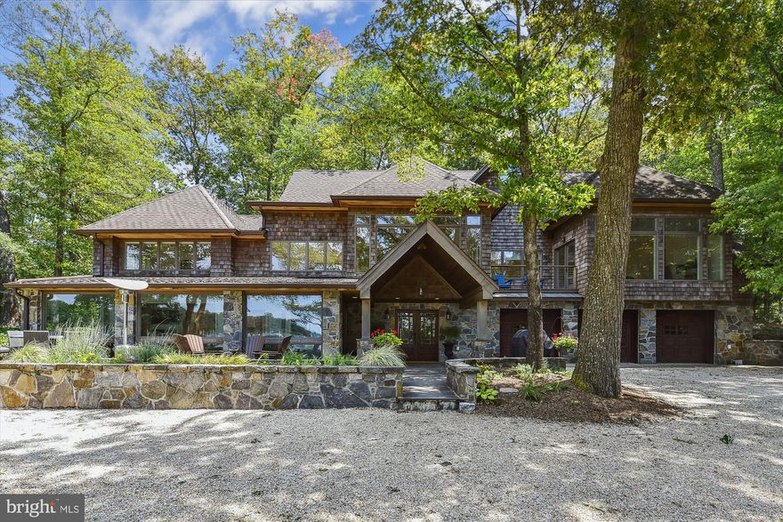 A Once in a Lifetime opportunity to own an updated 1920’s Severn River Waterfront Estate.   As you approach the front yard, you’re greeted by a private sandy beach and dock, featuring a 13,000 lb boat lift and a waterfront gazebo - trademark qualities of this unique listing.  Watch eagles fly by and enjoy beautiful sunsets from your patio that extends the width of the home, creating a perfect space for entertaining.   In 2022, the owner completed a major renovation that included a brand-new gourmet kitchen with high end appliances and updated all the bathrooms.  The owner also created a 5th bedroom and a 5th bathroom – all the 5 bedrooms have their own full bathroom.  The open-concept main level design includes floor to ceiling windows with views of the Severn River.  The open kitchen, dining and great room provides another fantastic entertainment space for guests.  On the main level you’ll find a private bedroom with a full bathroom, a half bathroom, and a secluded TV room.  Attached to the TV room is a bonus space that is currently used as the 6th bedroom, but could be an office, gym, or flex space.  To complete the renovation, the house was painted, decorated, and furnished by a professional interior designer.   There is an extra-large 3 car garage with a utility room behind it.  As you walk upstairs you enter another family room with vaulted ceilings that is the perfect space to read, play games or just relax.  The second floor features 2 Primary Suites with private bathrooms and fireplaces at each end of the home.  Two bedrooms, two full bathrooms and a laundry room complete the 2nd floor to this estate. All the upper level bedrooms enjoy water views.  This is a home that you just need to see to appreciate all that it has to offer – Set up an appointment now to check this beauty out!